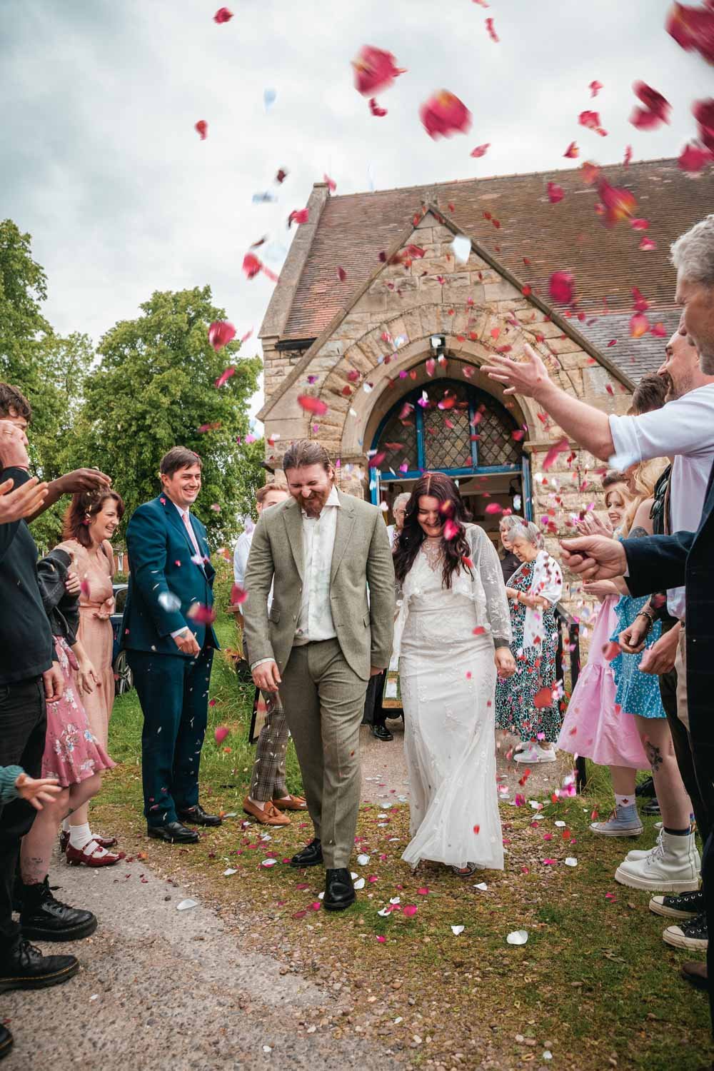 confetti is thrown over the bride and groom outside a Lincoln Orthodox church