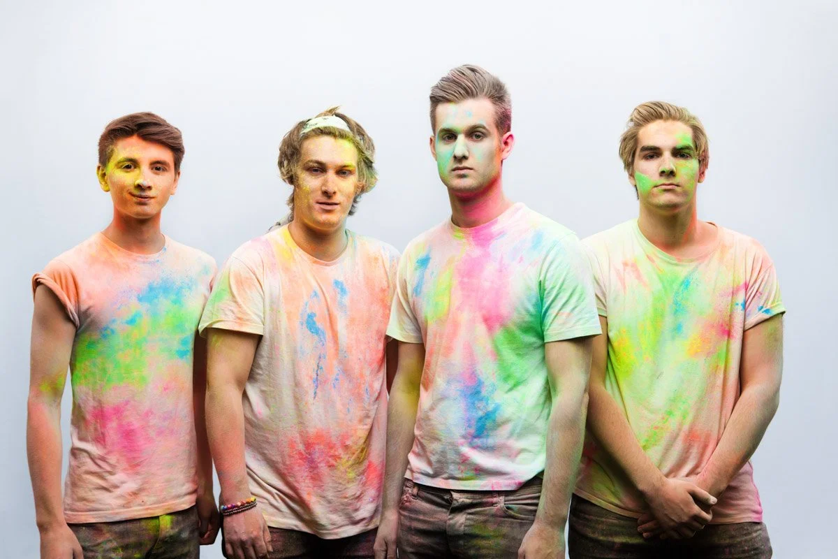 Derby band The Rascals in a photoshoot, covered in brightly coloured paint powder