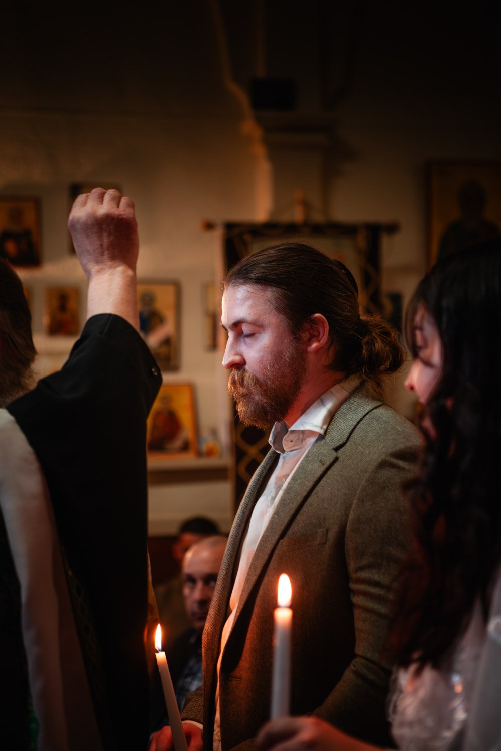 priest anoints groom during Orthodox ceremony in Lincoln