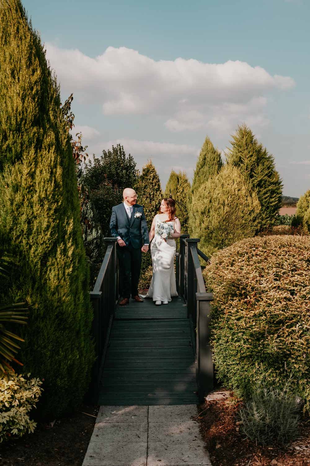 bride and groom cross bridge