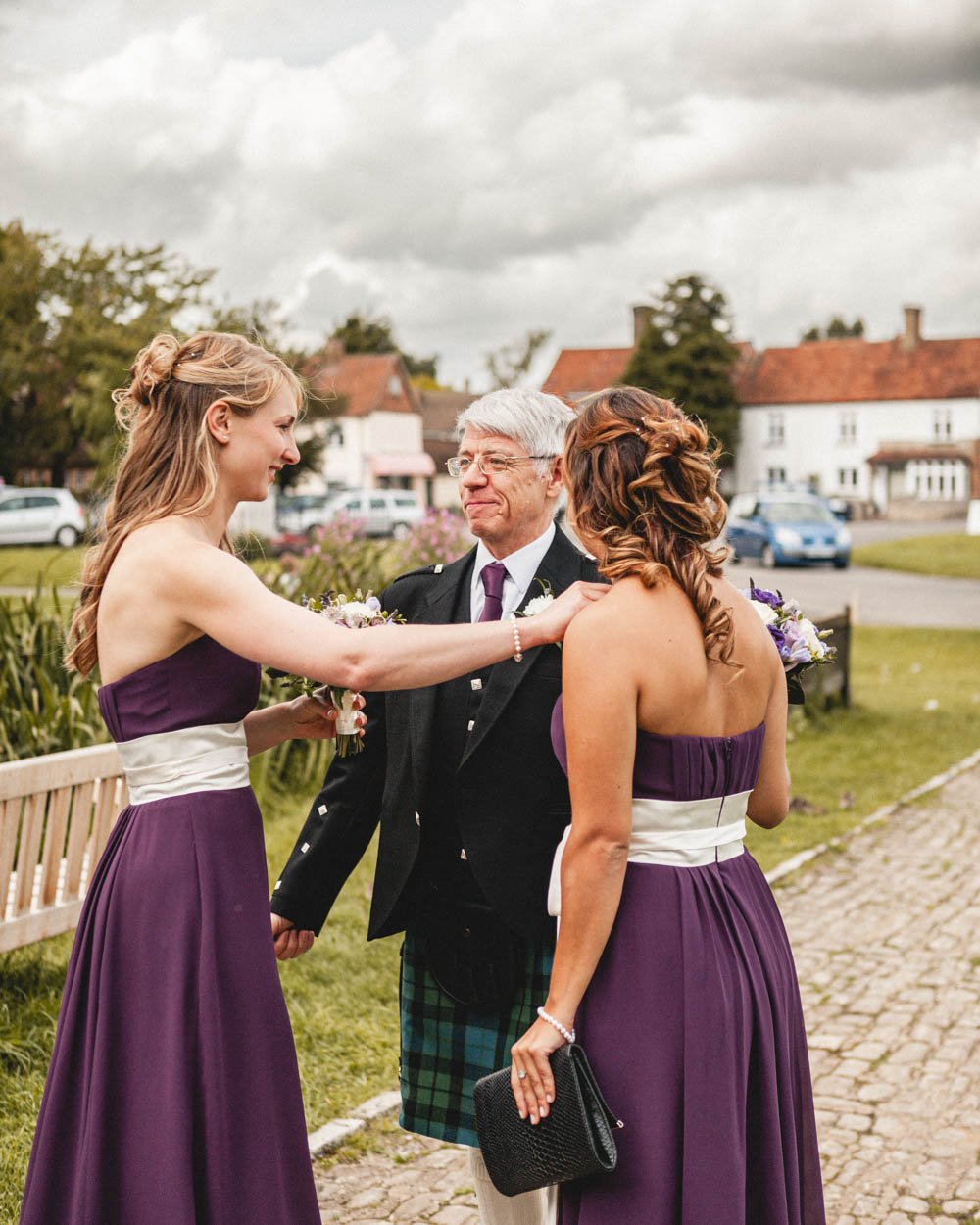 bridesmaids greet a man in a kilt