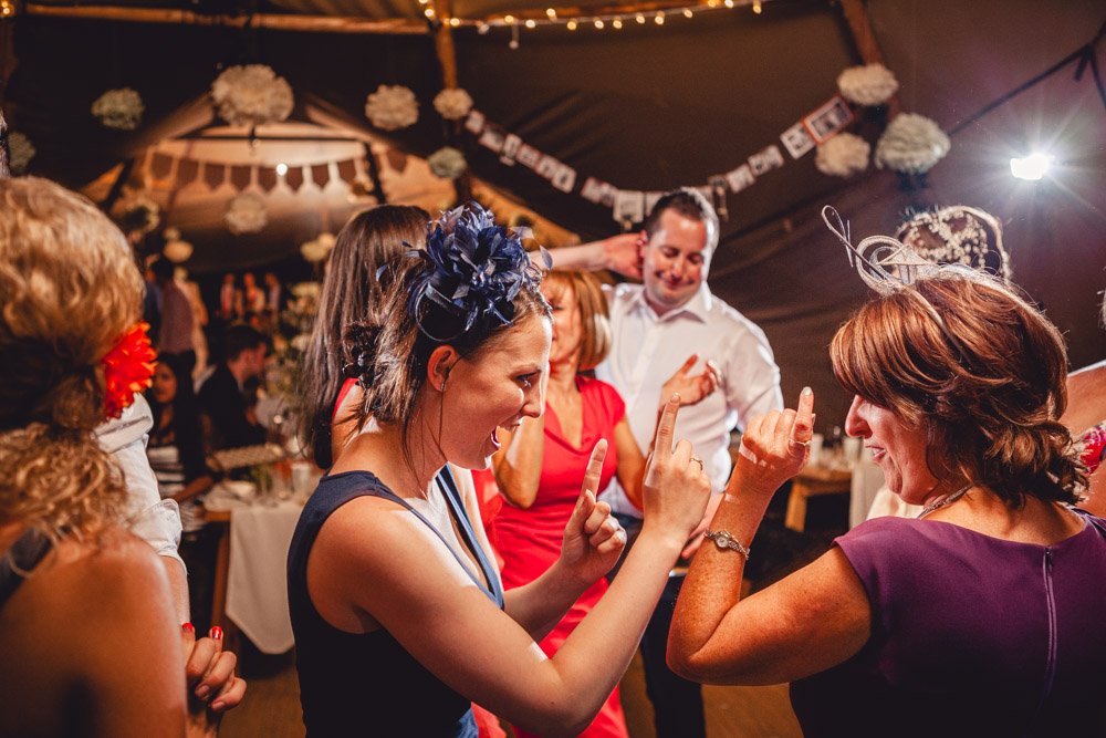 wedding guests dance in a tipi