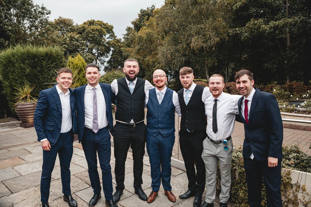 groom with friends in a garden