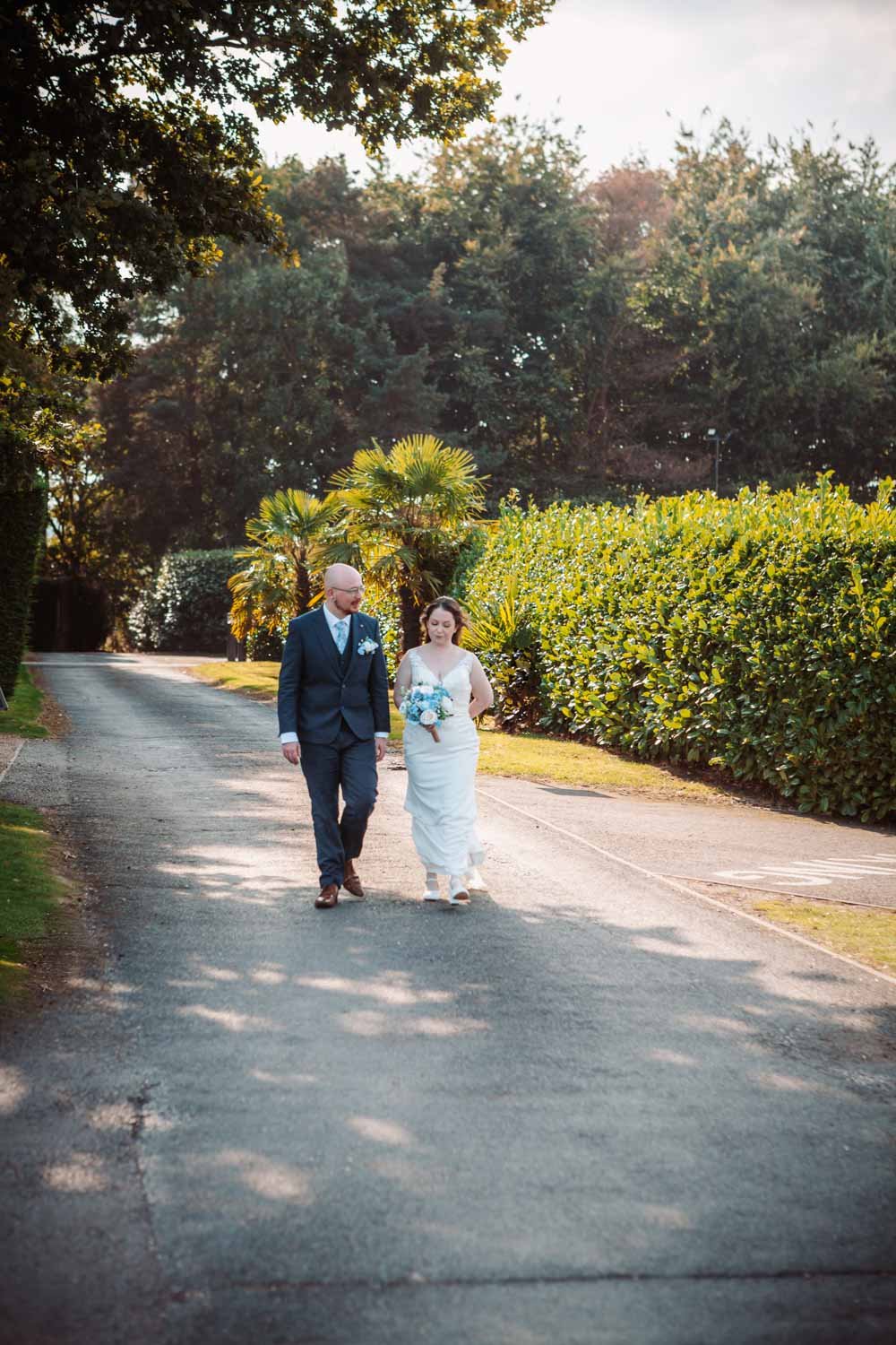 bride and groom walk along the drive at Goosedale, Nottingham