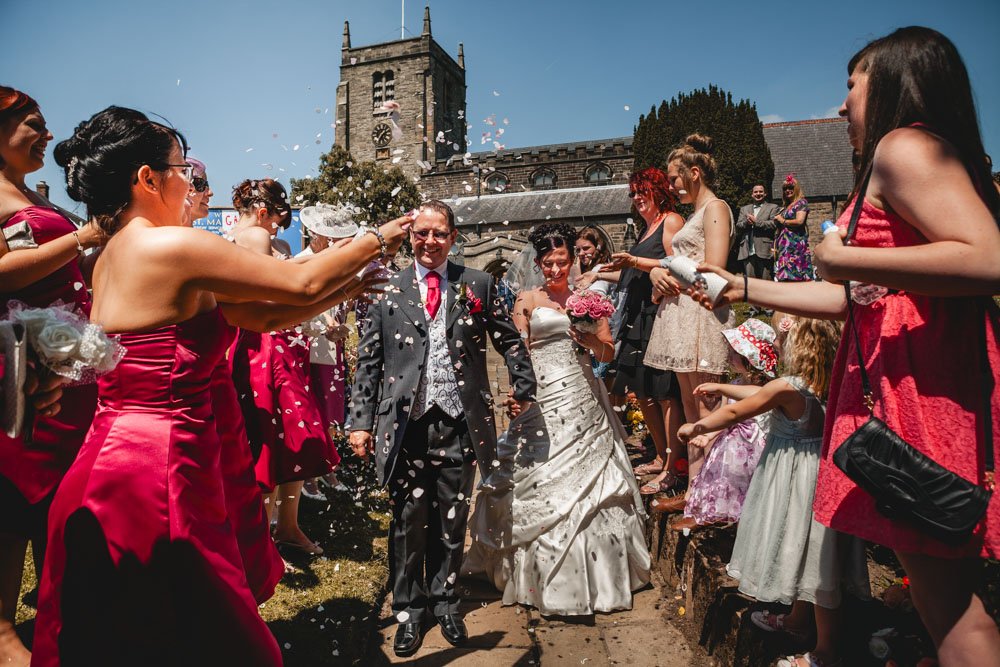 Bride and groom in confetti outside Nottingham church