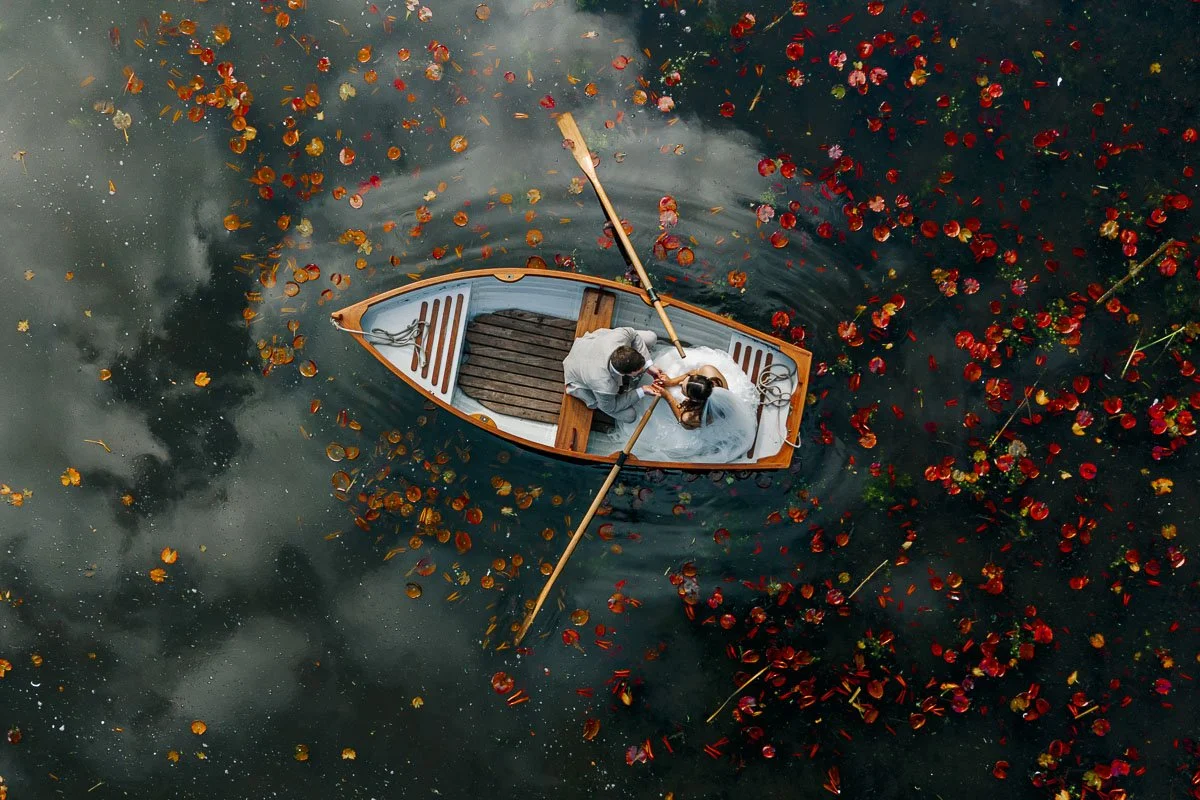 drone shot of bride and groom in a rowing boat