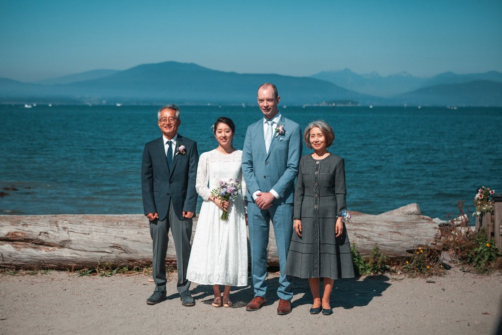 parents of the bride stand with bride and groom in destination wedding