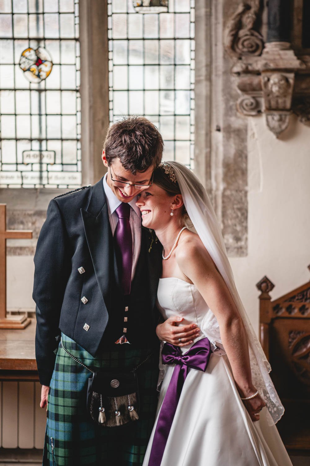 bride and groom share intimate moment in church ceremony