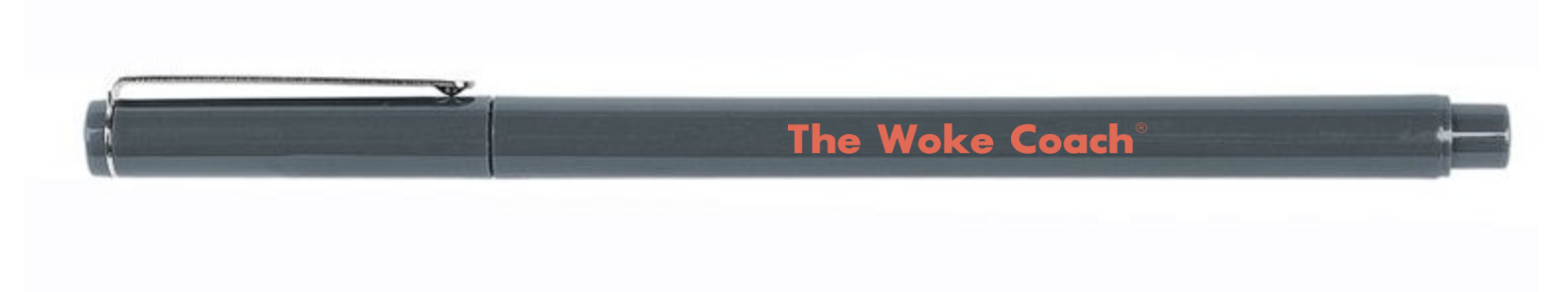 A gray retractable ballpoint pen with the words "The Woke Coach" written in orange on the side.