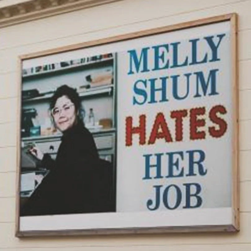Sure, she&rsquo;s smiling. But the tired eyes, cramped desk, and limp hand on dated office gear tell another story: Melly Shum hates her job. Perhaps she works in what anthropologist David Graeber has in mind in his book Bullshit Jobs (Reeve, 2020). 