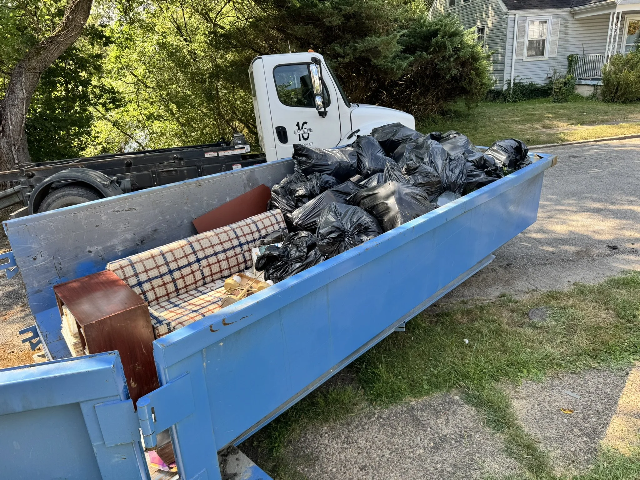 Junk Removal Loading Dumpster