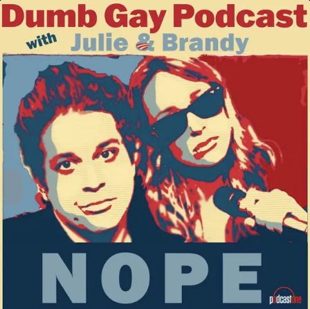 A graphic promotional image for the 'Dumb Gay Podcast' featuring Julie and Brandy. The design uses bold red, blue, and beige colors and shows two women, one with short dark hair, and the other with long wavy hair wearing sunglasses, holding a microphone. The text includes the podcast title and hosts' names.