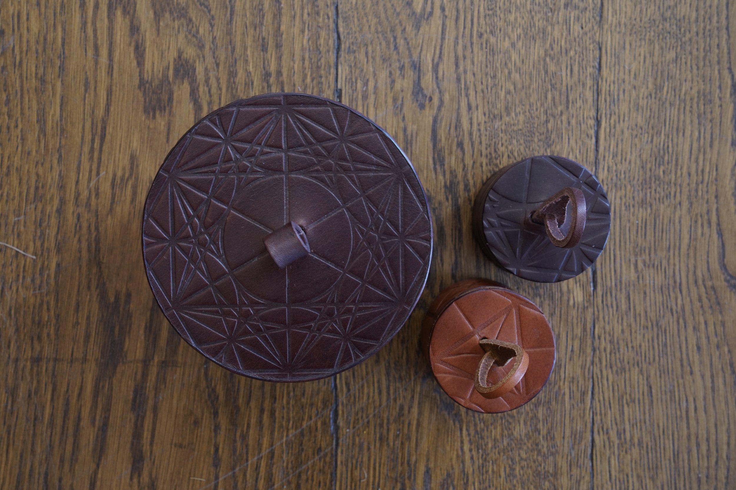 Justin Capp leather cylinder boxes above.jpg