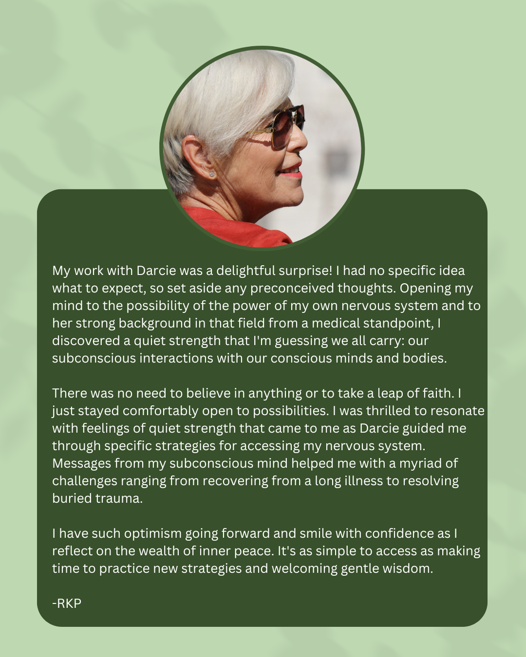 A profile of an older woman with short white hair, wearing sunglasses and a red top, against a light background.