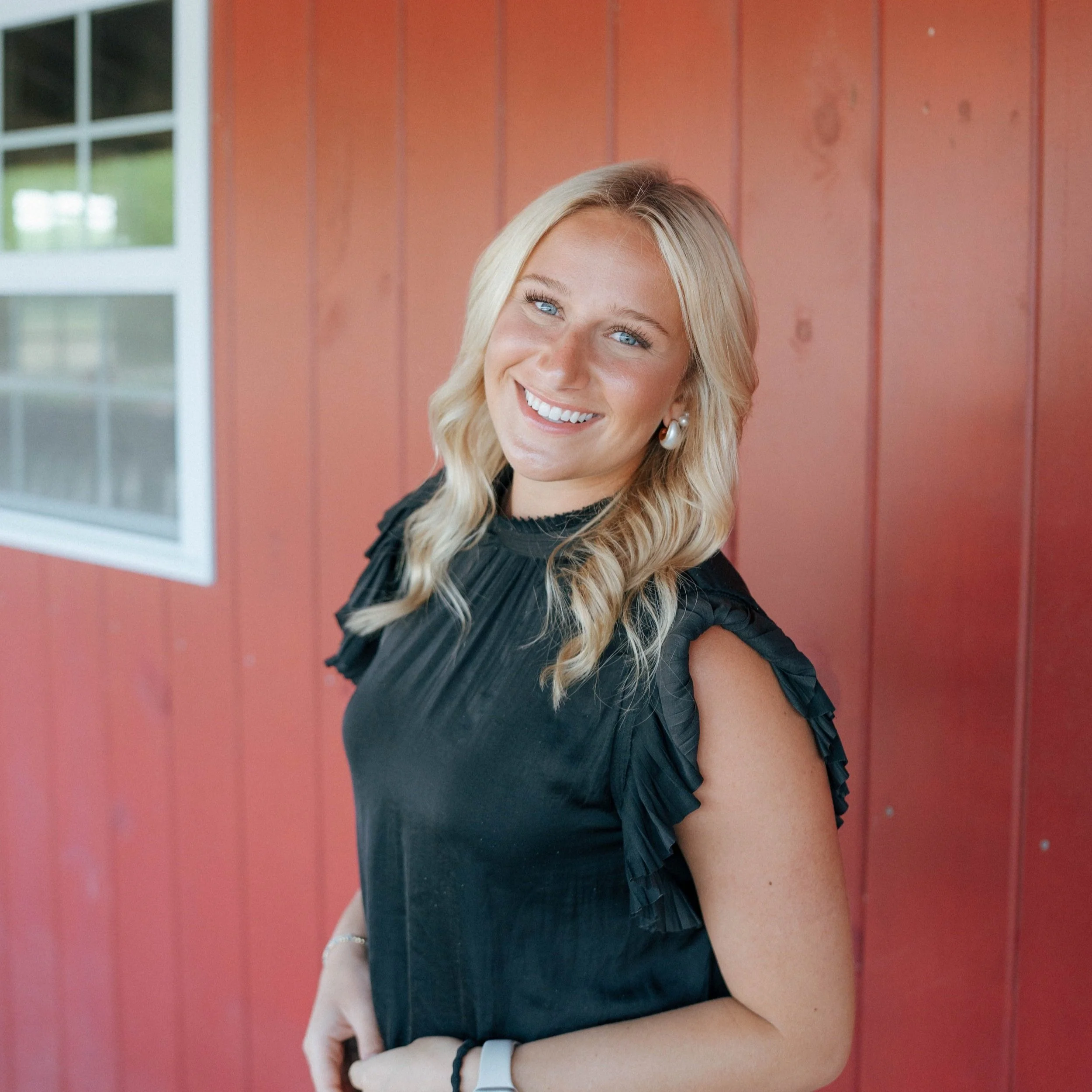 Woman smiling with a sash that reads 'Miss Congeniality'