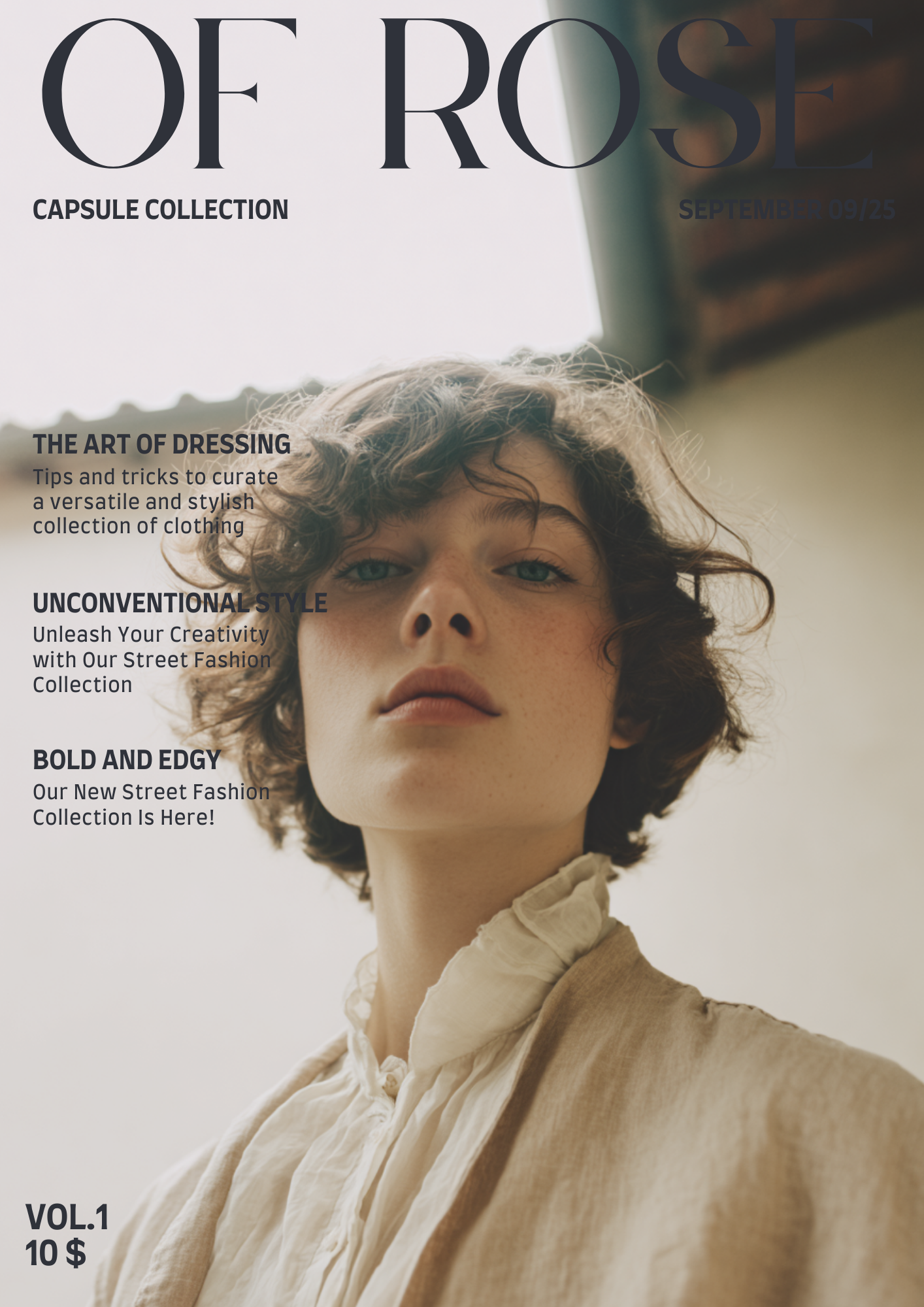 A woman with short curly hair and fair skin, wearing a light beige blouse with ruffles at the collar, looking directly at the camera against a neutral background.