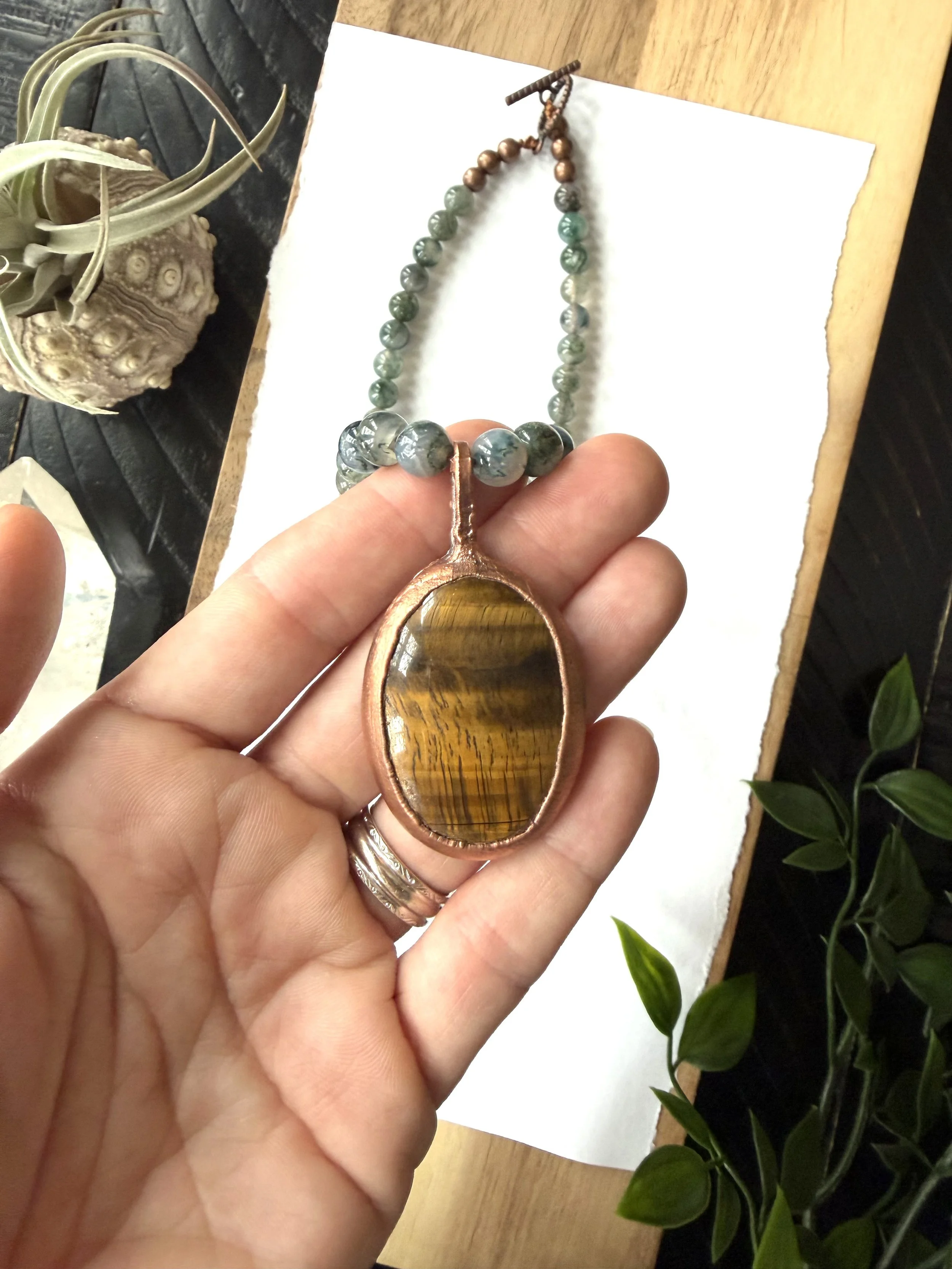Oval Tiger Eye Cabochon set in Electroformed Copper on a hand beaded Moss Agate Necklace finished with Toggle Clasp