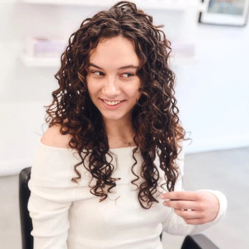 After transformation photo of Neisha showing defined, voluminous curls styled at Gato Loco Hair in Tauranga.