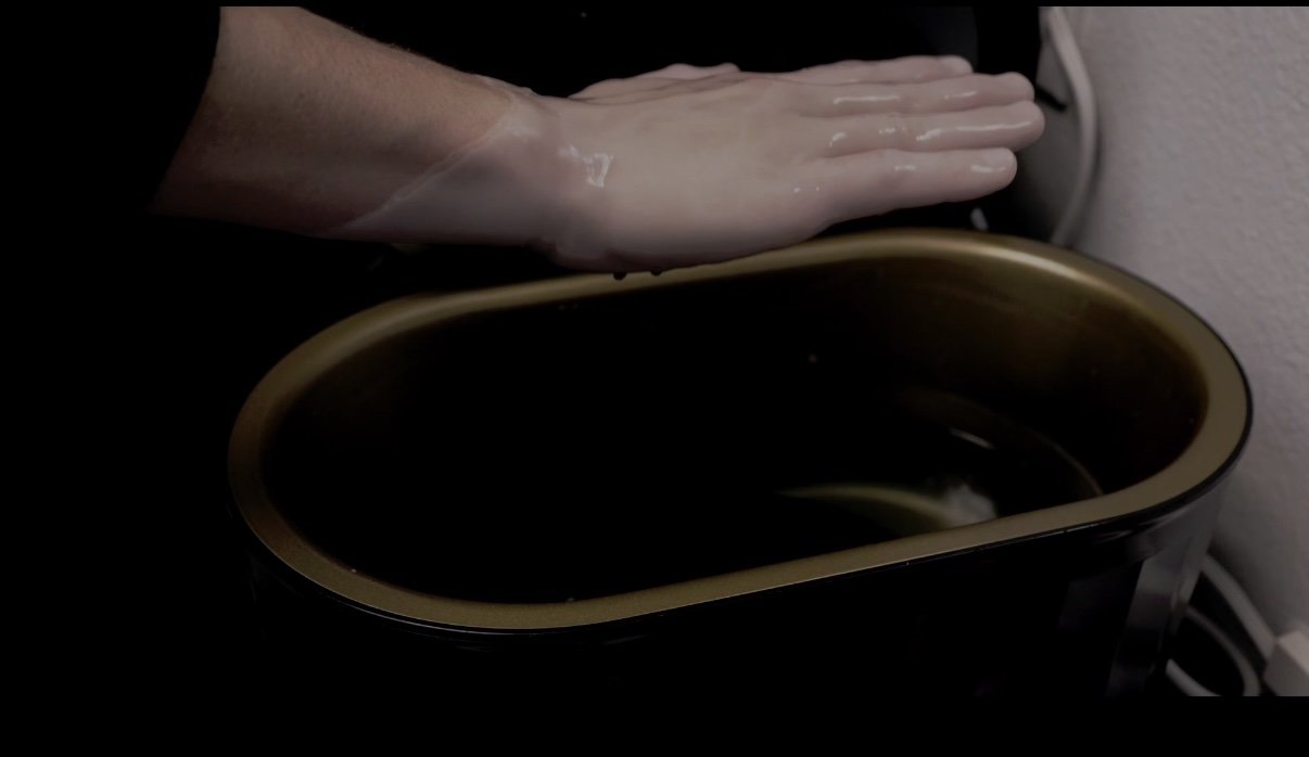 Paraffin hand wax dip on a clients hand