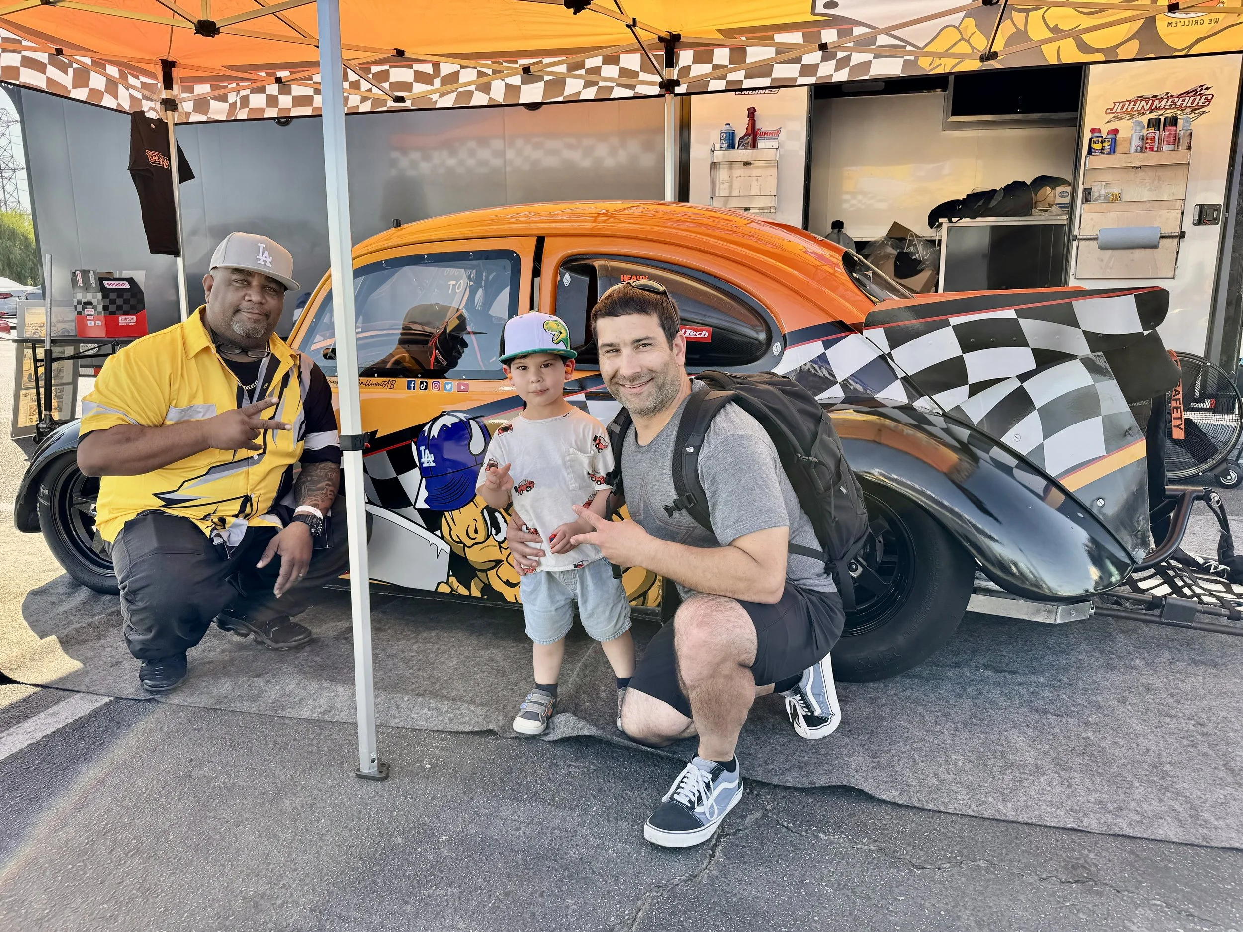 Aaron Brown of Smokin' and Grillin' with AB with Kevin Daigle at Irwindale raceway. Posed in front of Aaron's race car at an event in 2023