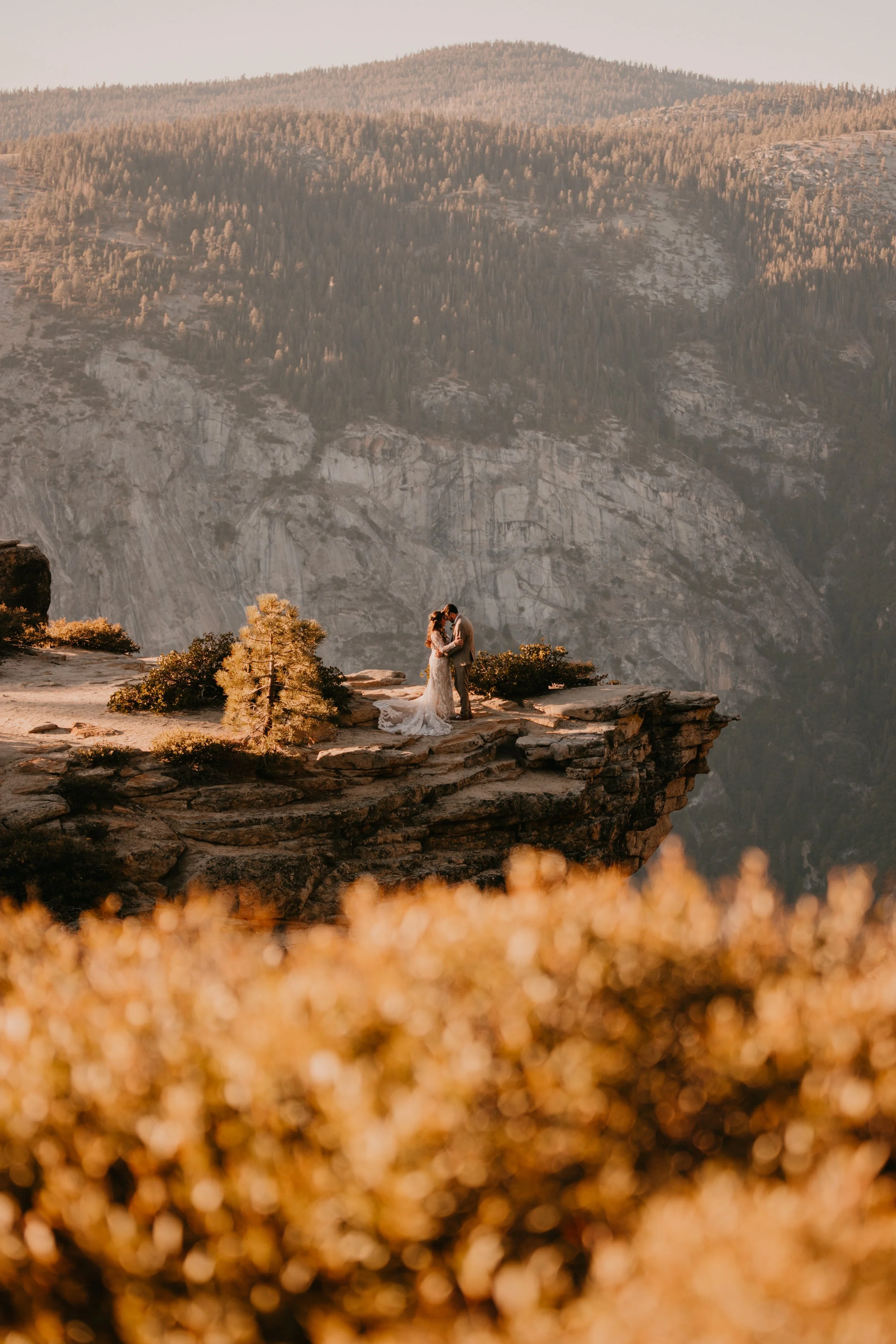 Wedding Couple Posing on Cliff Edge in Yosemite National Park.