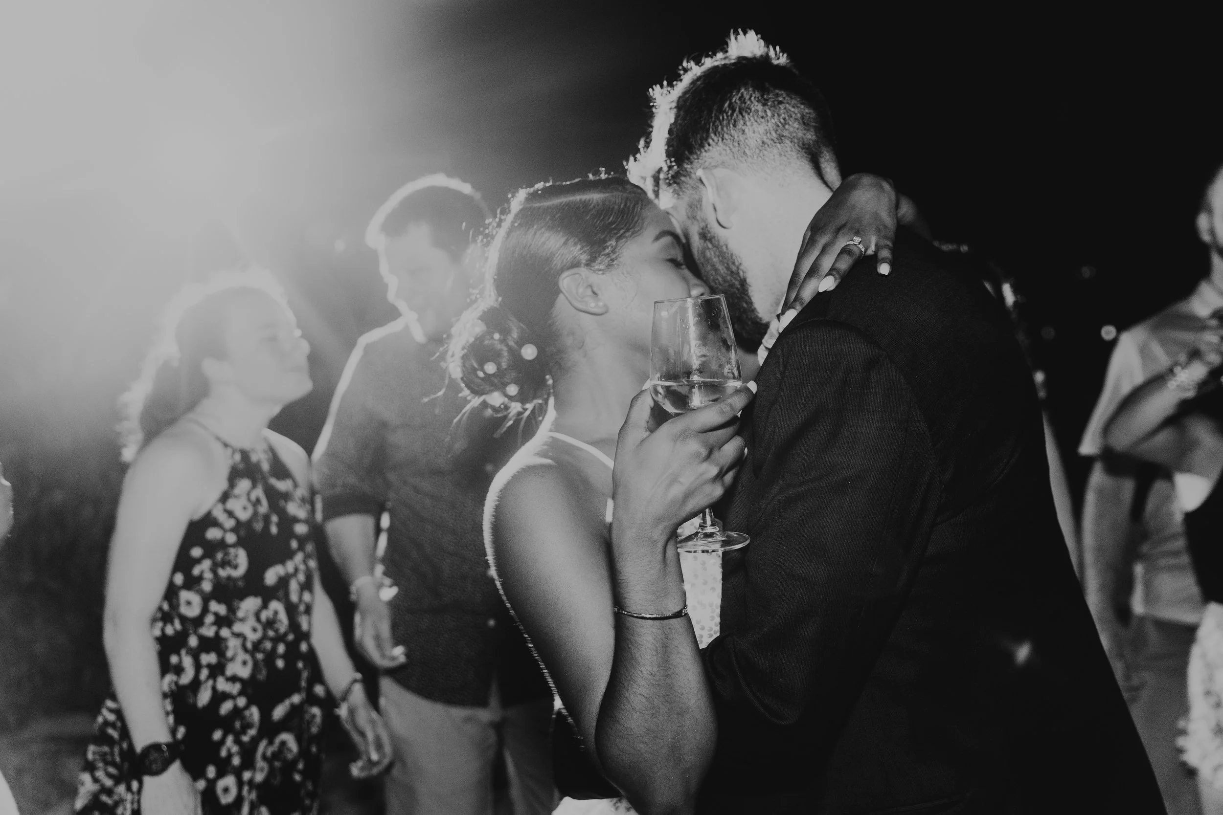 Black and white wedding couple enjoying a moment slow dancing during wedding reception in Cancun Mexico.
