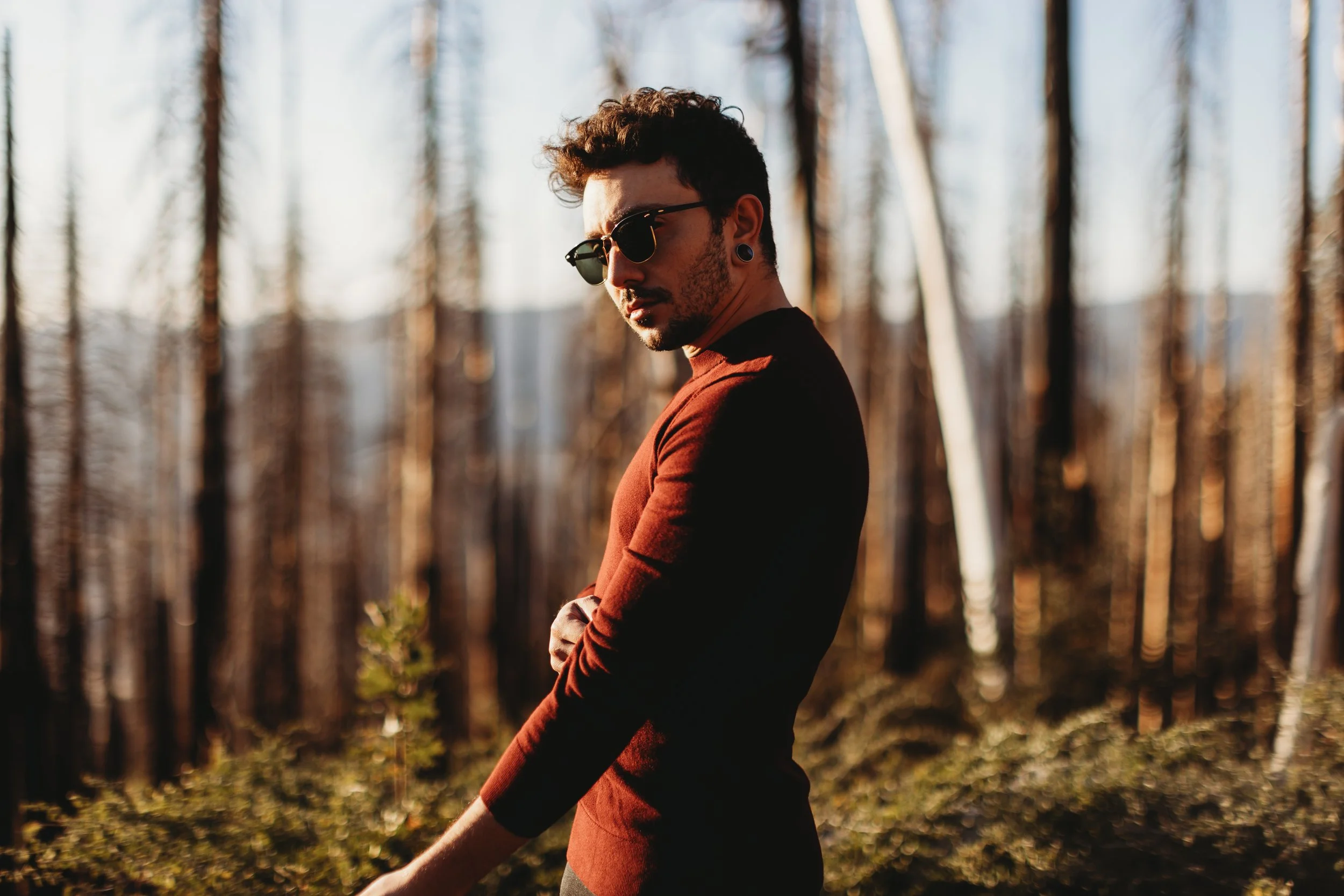 Alternative male model posing in Yosemite National Park.