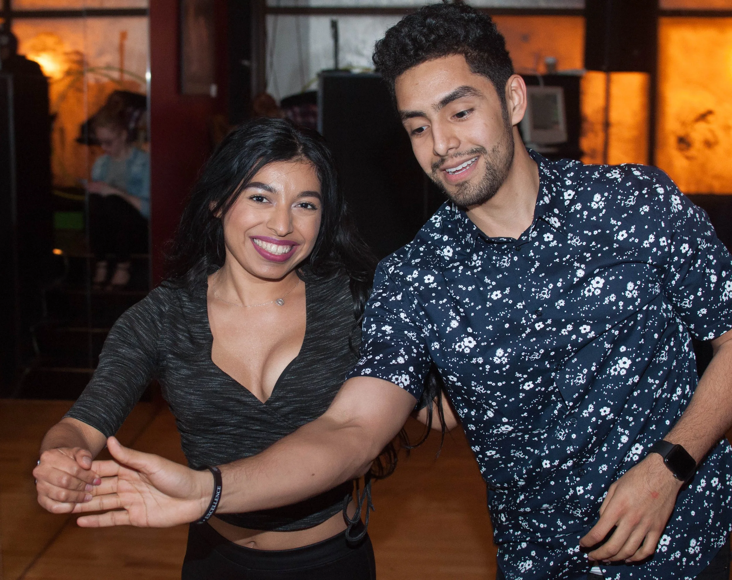 A man and woman smile while dancing at a Latin Expressions event. | Latin Expressions Dance Studio Indianapolis