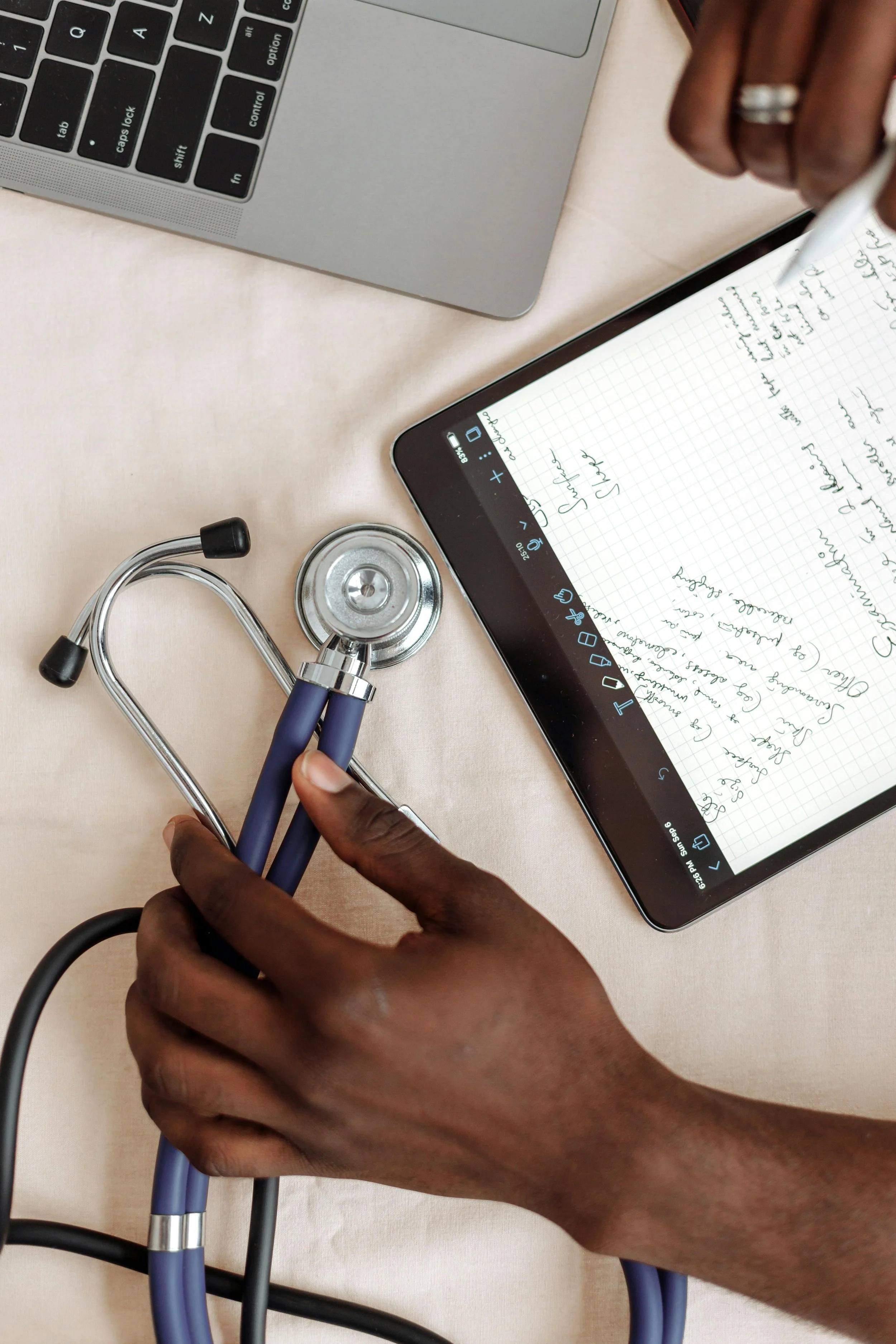 A person's hand holding a stethoscope