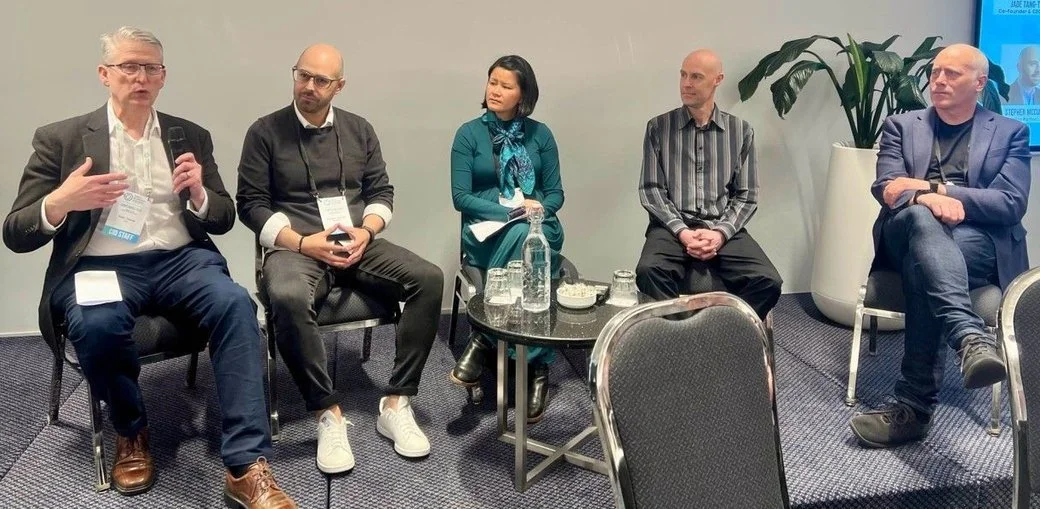 Jade sits at the centre of a panel of 5 speakers at the CID conference