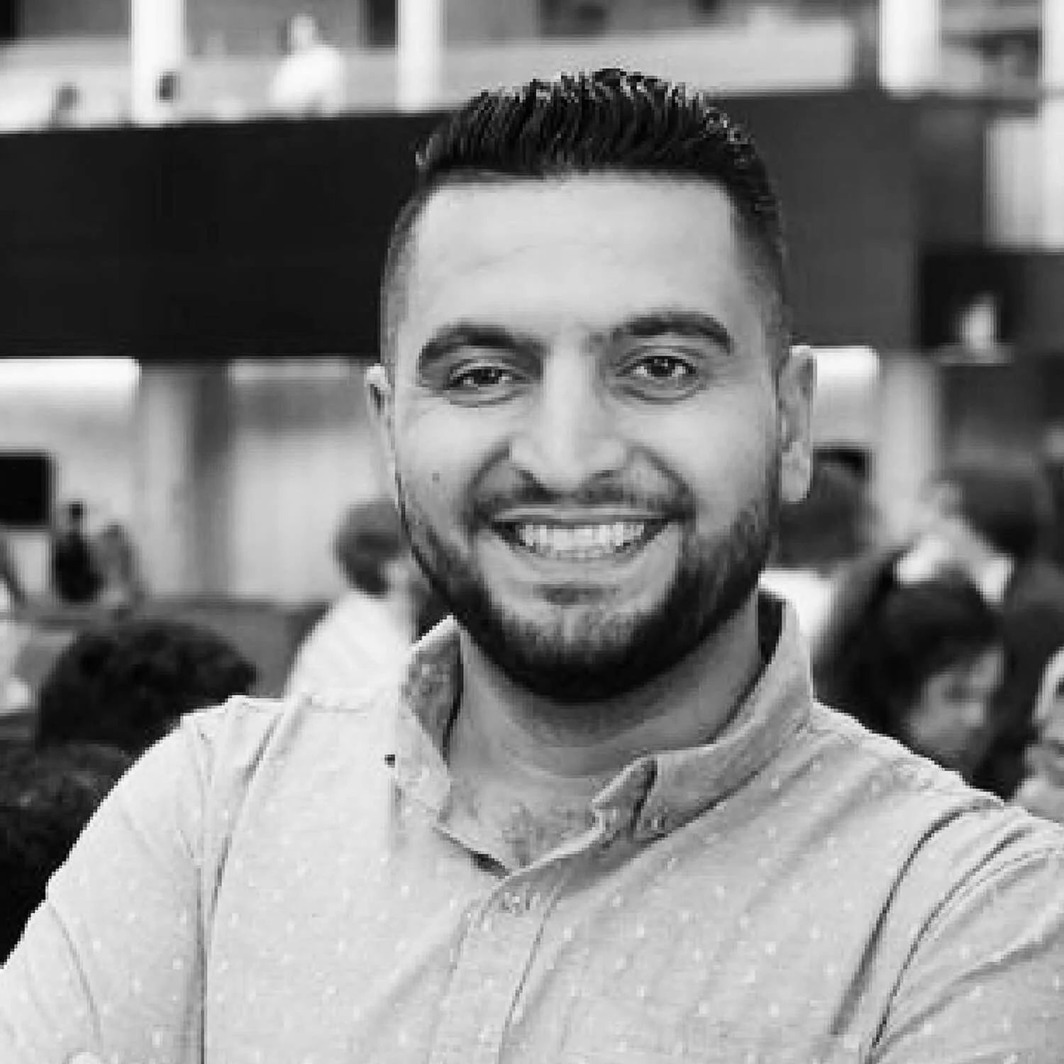 Picture of Kodrean. He is smiling. He is indoors and wearing a patterned shirt