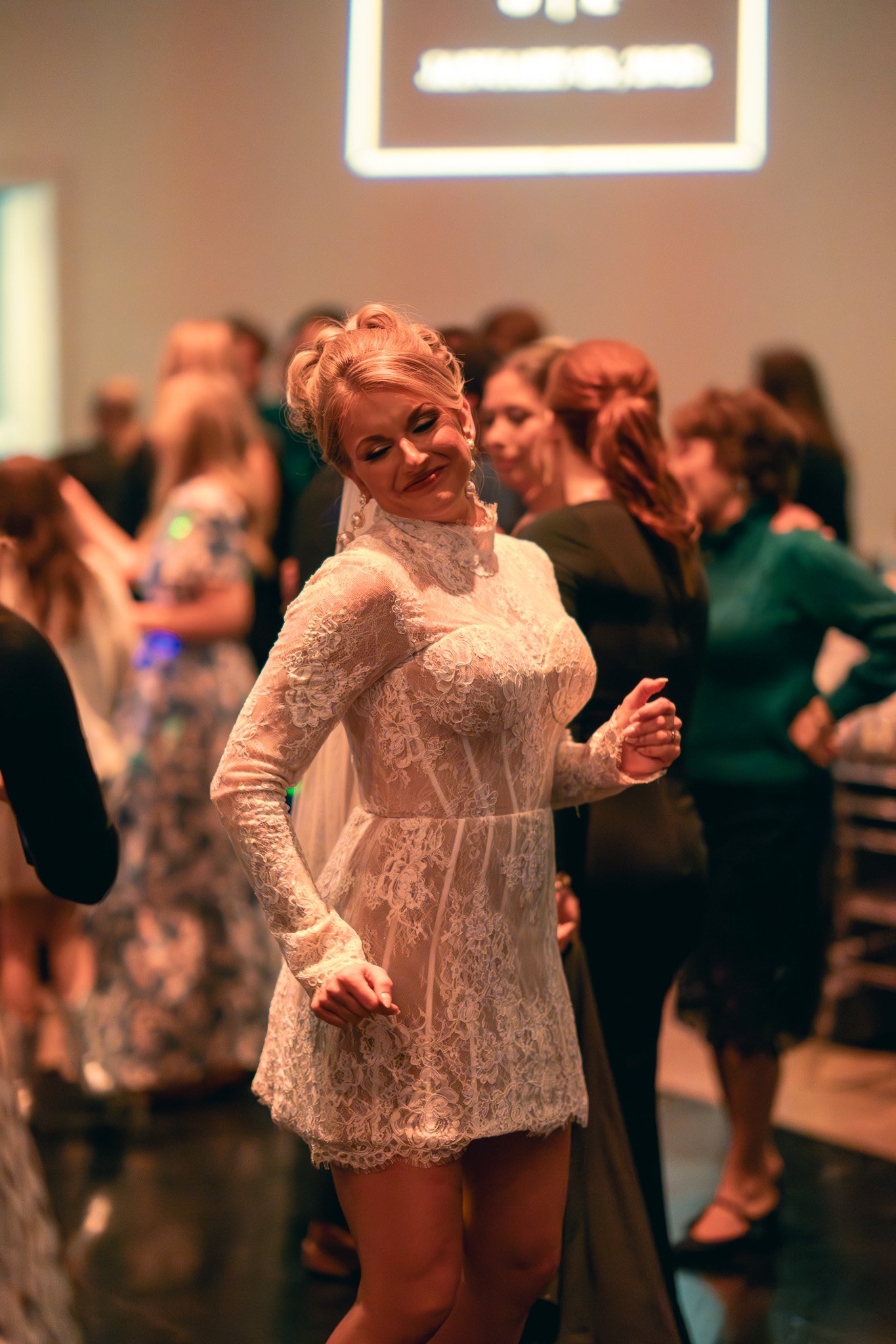 Woman in lace dress dancing at a formal event