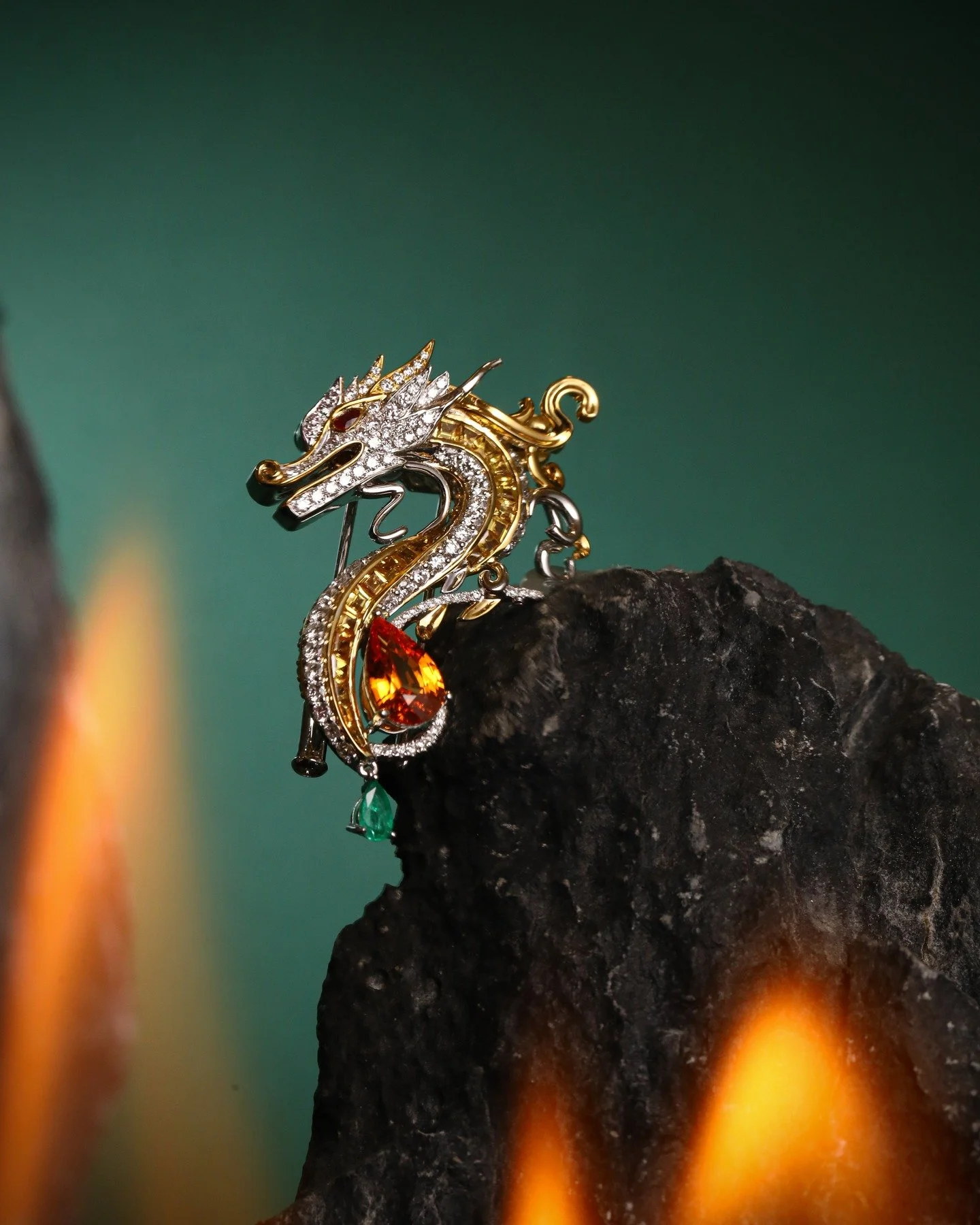 Dragon Brooch

A modern dragon rendered in 18K dual-tone gold&mdash;guardian, force, and continuity.
Centered by a 2ct vivid orange Fanta garnet, with custom-cut yellow sapphire, diamonds, ruby eyes, and an emerald tail drop.

In my culture, the drag