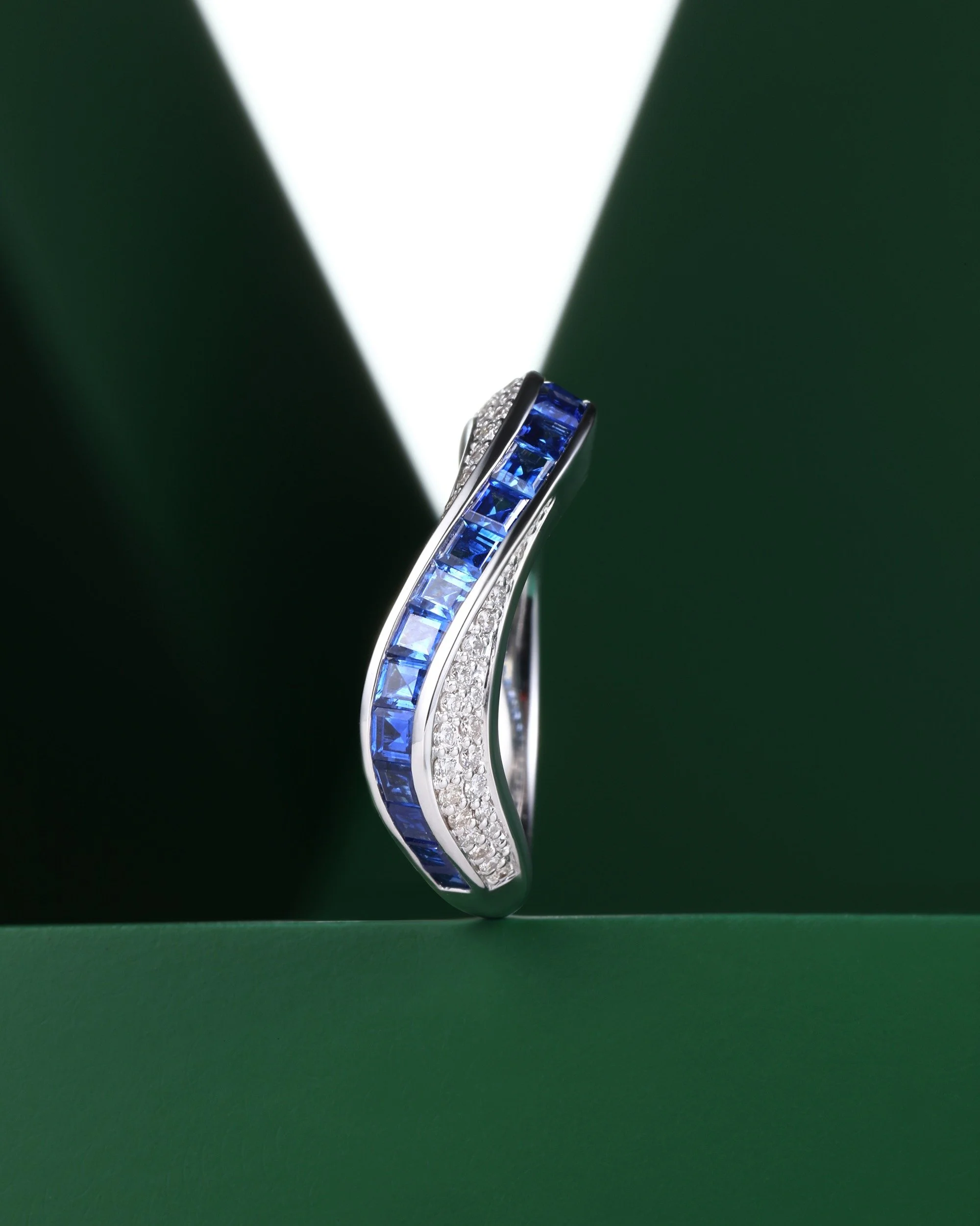 A current set in motion. Square-cut sapphires channel across the band in a single rising line, pav&eacute; breaking white along either edge. Stream collection.

#jewelrydesigner #finejewelry #danielyujewelry #customjewelry #highjewelry