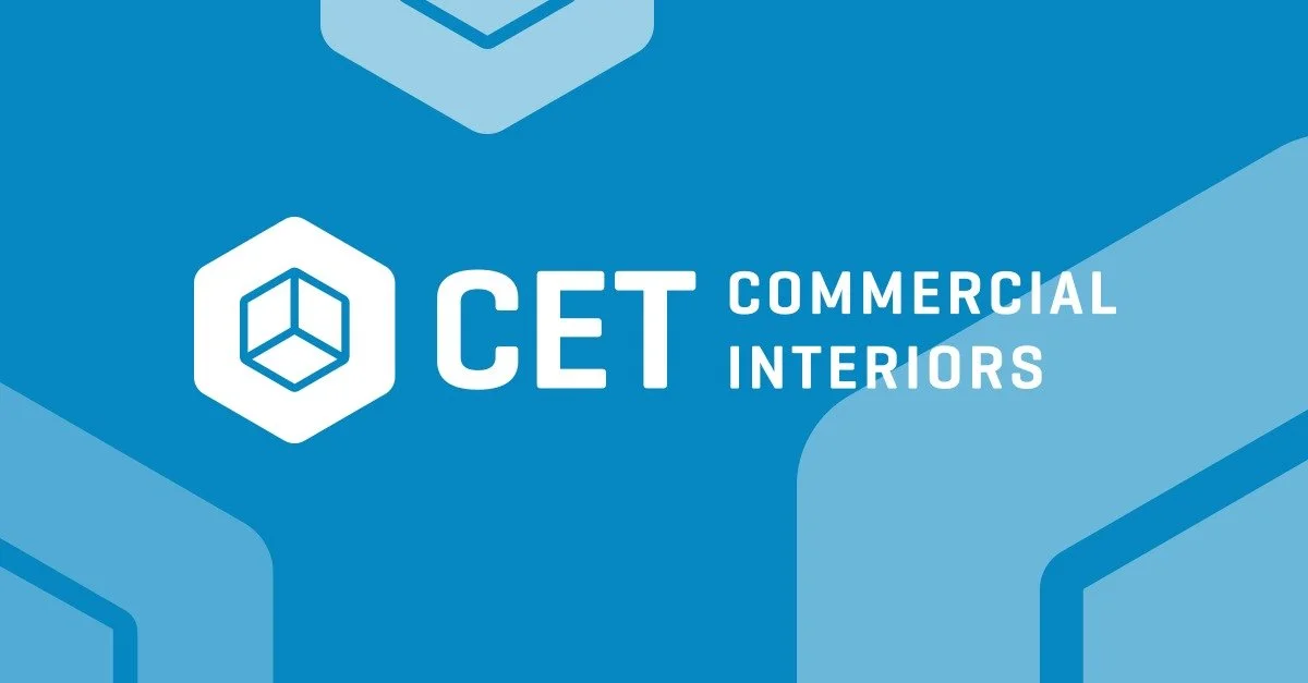 Logo for CET Commercial Interiors with a hexagon icon and text on a blue background.