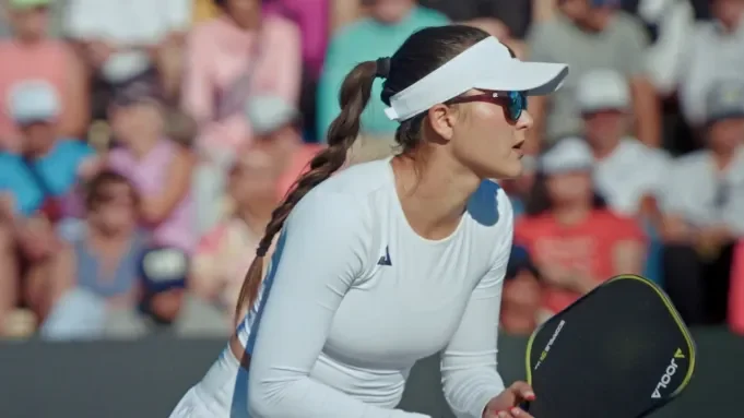 A woman playing pickleball