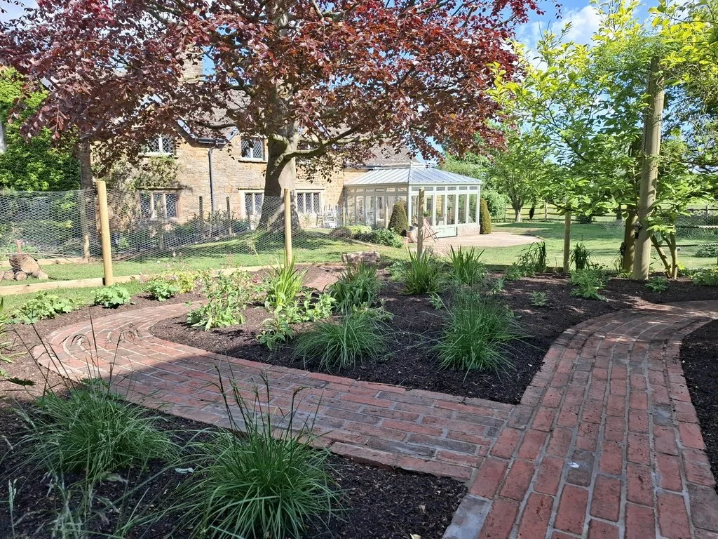 Creating a journey through the garden, we designed a clay paver pathway to snake through a large planting area offering a sense of discovery and intrigue in this large mature country garden. We cleared most of the existing undergrowth and replanted w