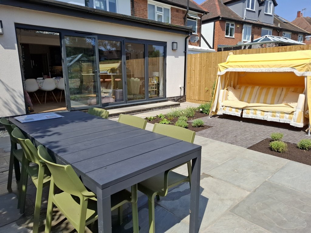 A reworking of this space, we changed the configuration of the existing paving to bring planting closer to the house and allow room for a dining table and statement swing seat from @odd_limited We reused the stone pavers and added beautiful clay pave