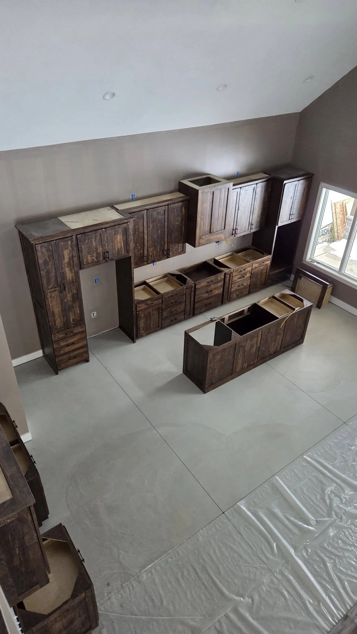 Custom wood cabinetry installation in progress inside new home build