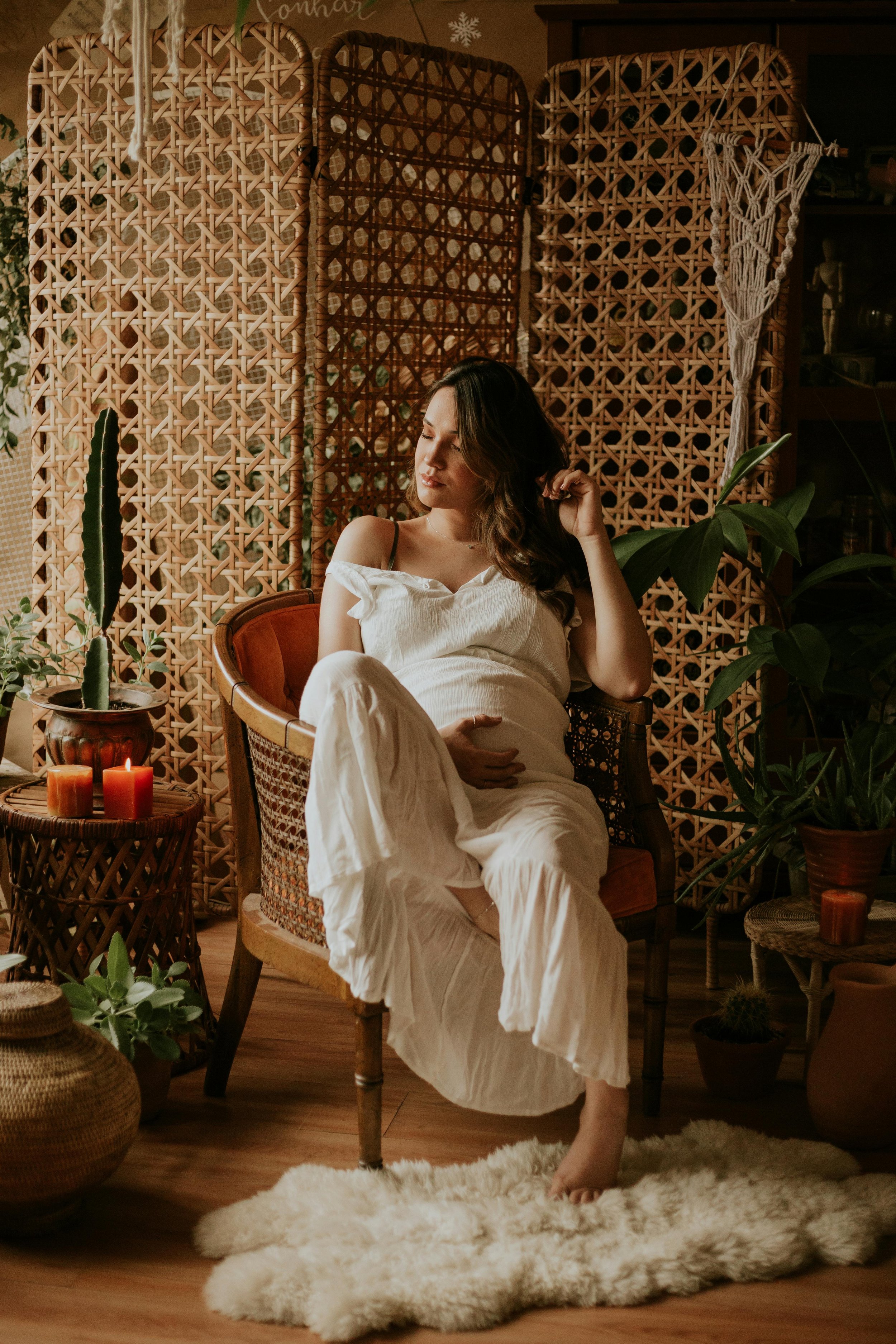 Pregnant woman relaxing on rattan chair