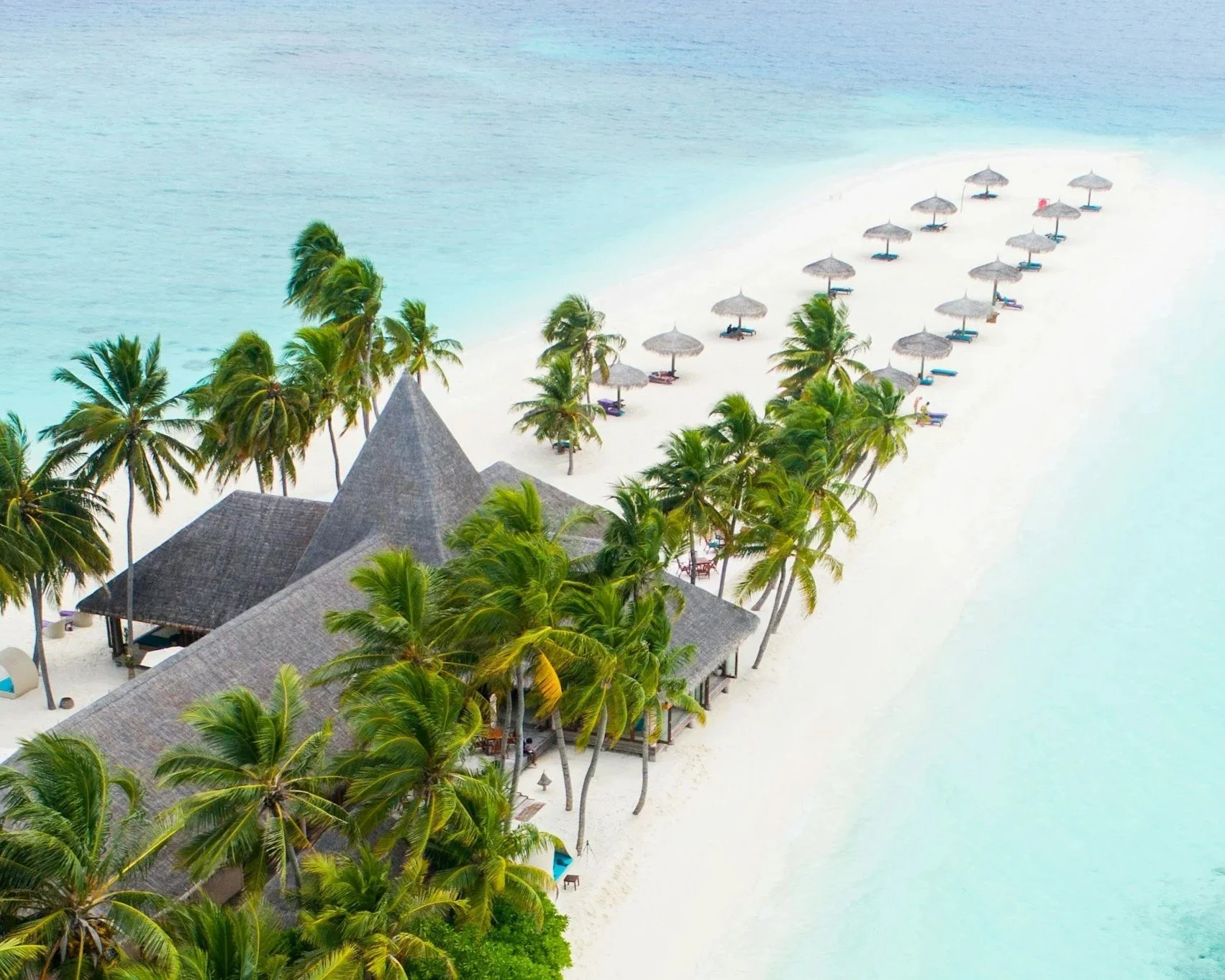 Multiple umbrellas at the end of island Maldives
