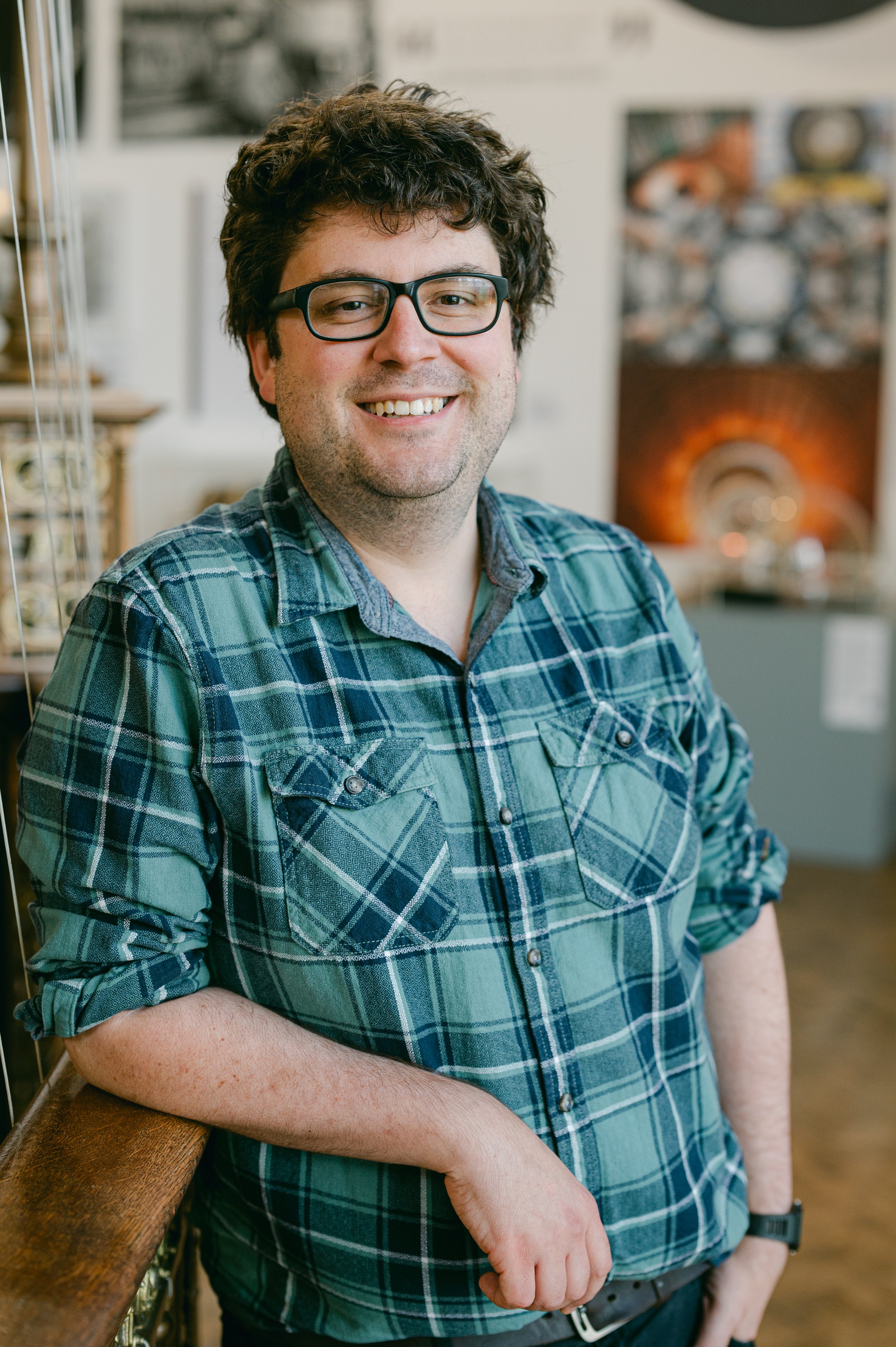Man with dark hair and glasses