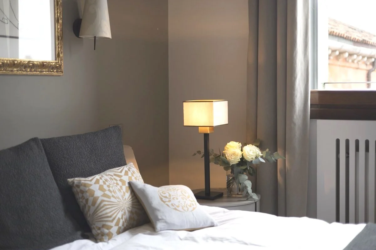 DOGIA Piccola lamp with Rubelli textile shade, sculptural base in a cosy bedroom interior