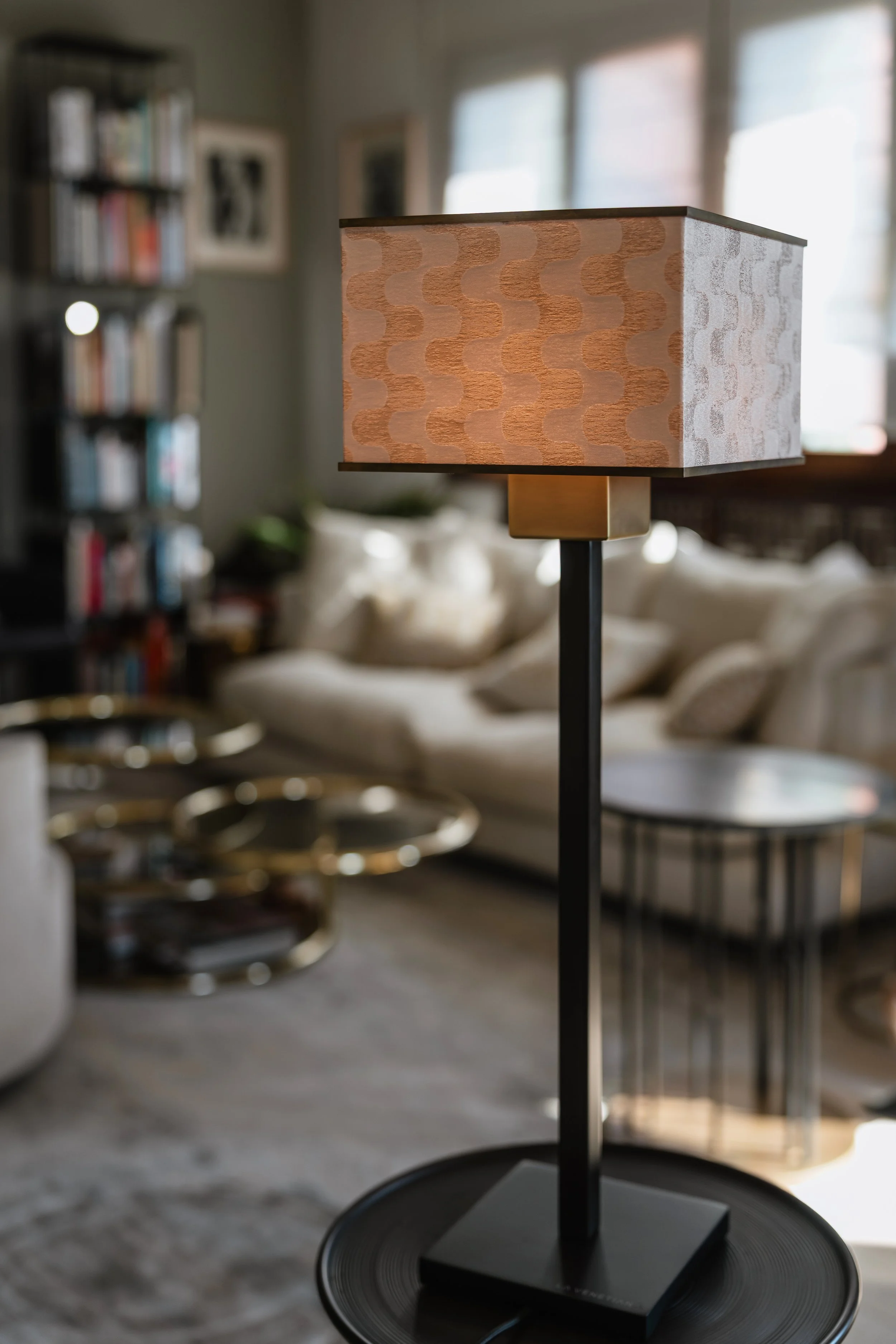 DOGIA Signature lamp with Rubelli copper-toned textile shade, in a living room interior