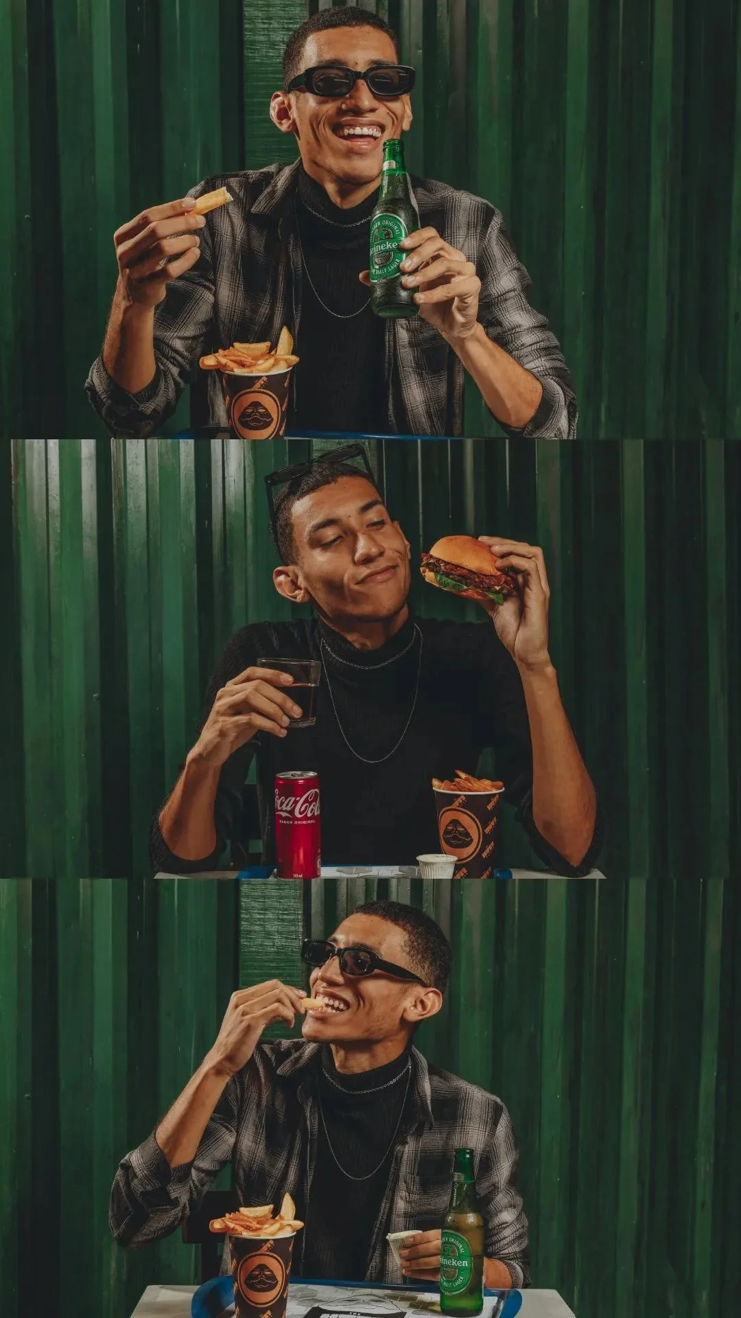 Homem sorridente usando óculos escuros, comendo batatas fritas, segurando uma cerveja Heineken, com fundo de painel verde, em um ambiente casual.