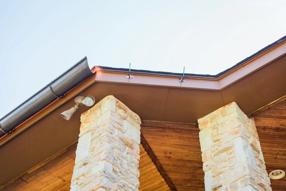 Stone pillars with wooden ceiling and metal gutter system
