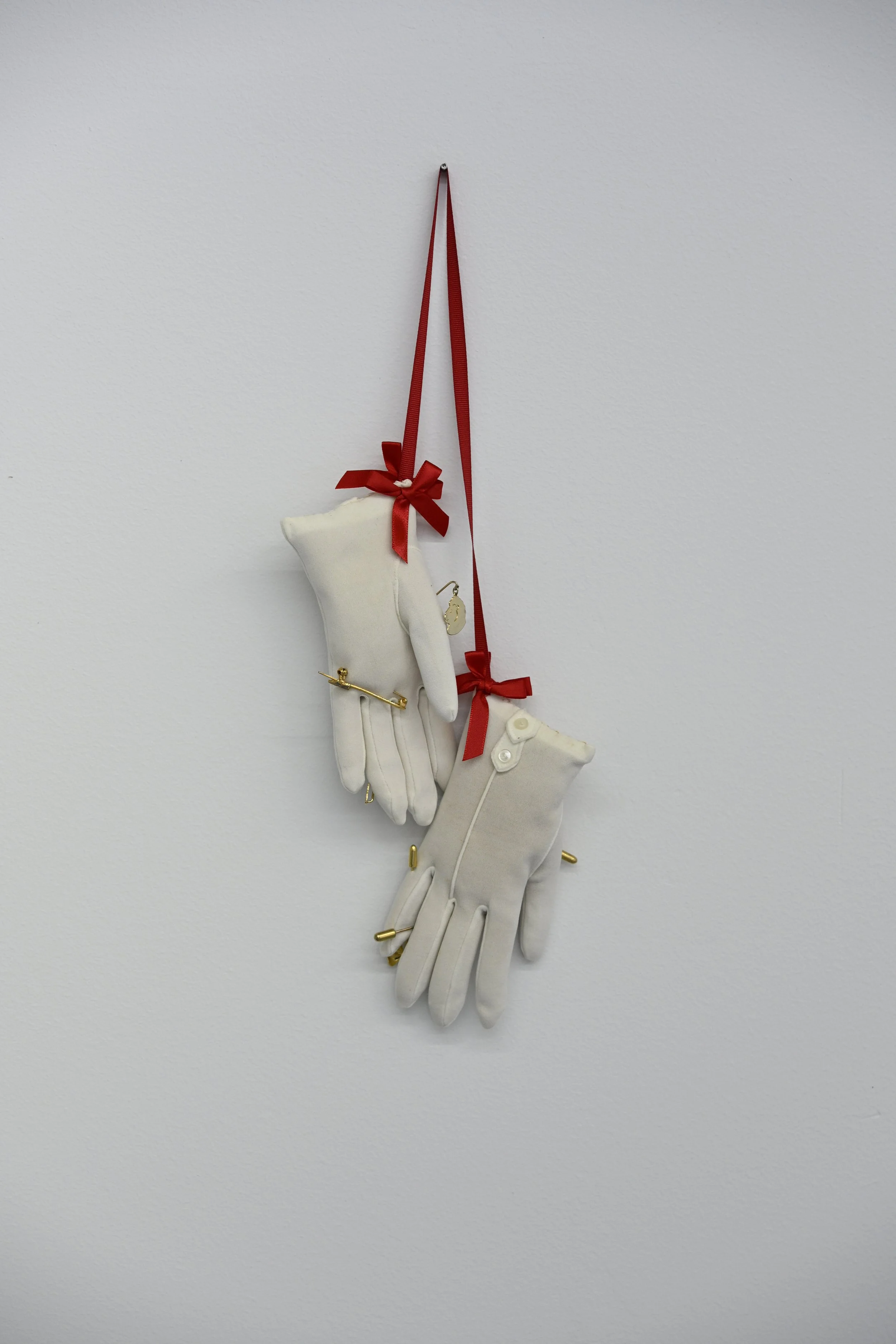 Pain (Girl 5 - 8) / 2026 / dead stock girl’s gloves, sawdust, vintage stick pins, ribbon / $500