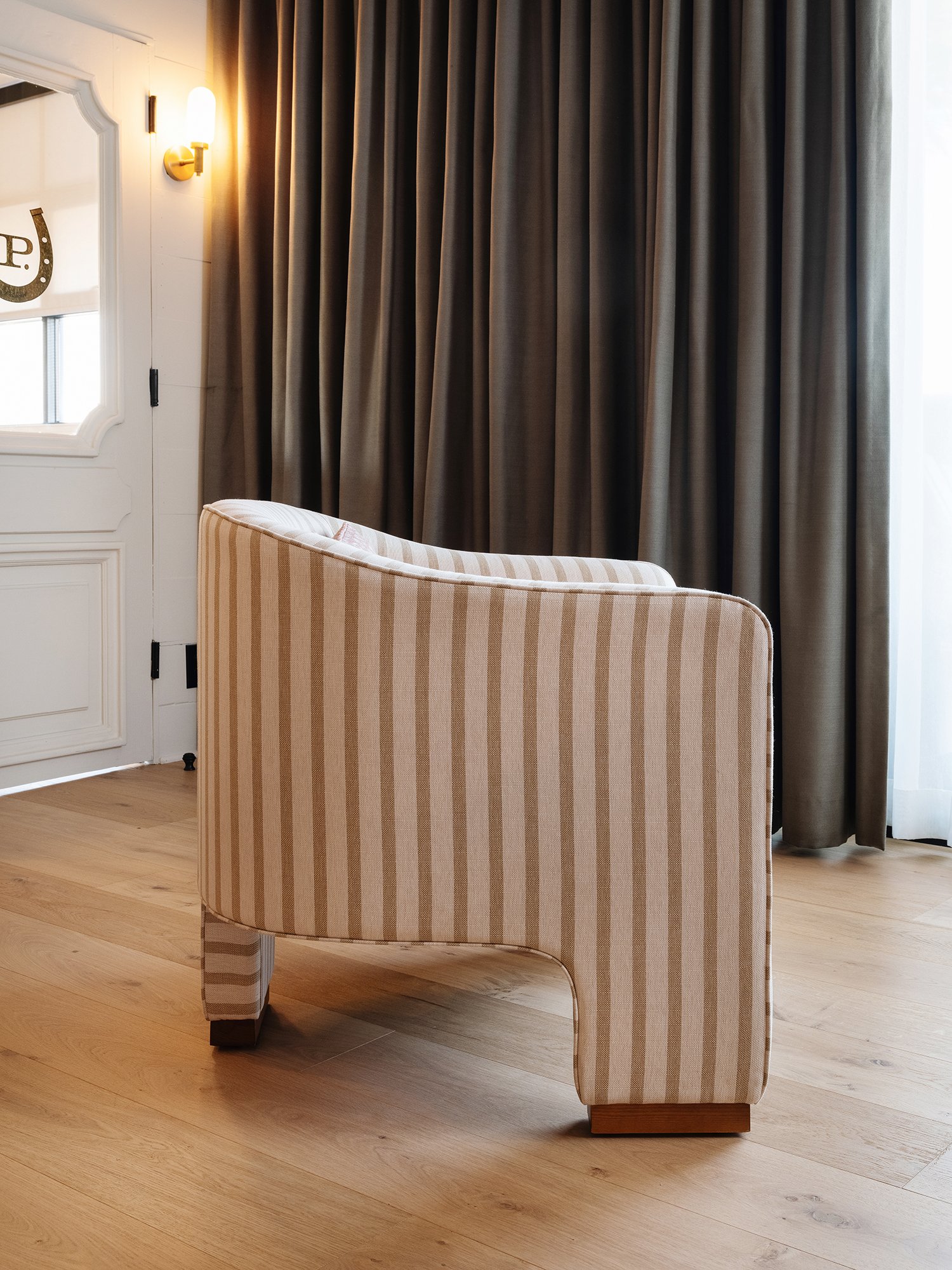 Side view of World Famous Accent Chair showcasing the three-legged design