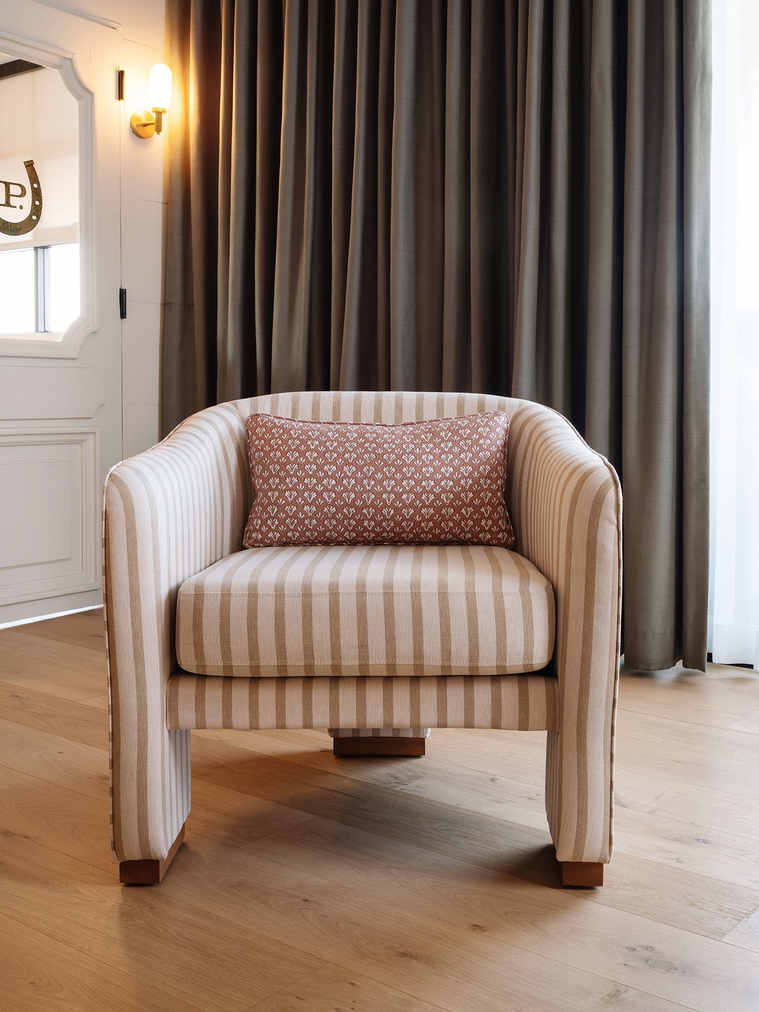 Front view of World Famous Accent Chair showcasing the three-legged design