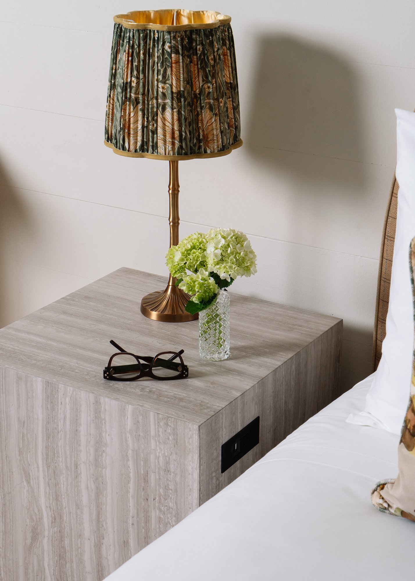 View of side of Orlando Bedside Table that shows convenience power outlet